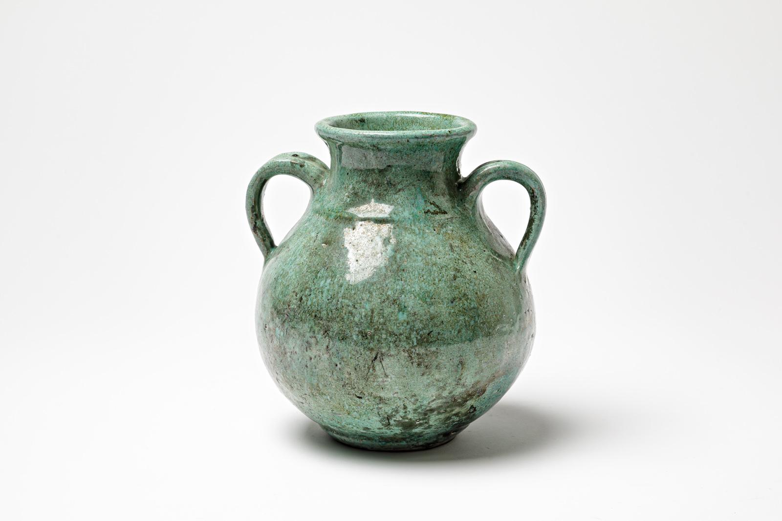 Green glazed ceramic handle pot by Gisèle Buthod Garçon. 
Raku fired. Artist monogram under the base. Circa 1980-1990. 
H : 6.7’ x 6.3’ x 4.7’ inches.