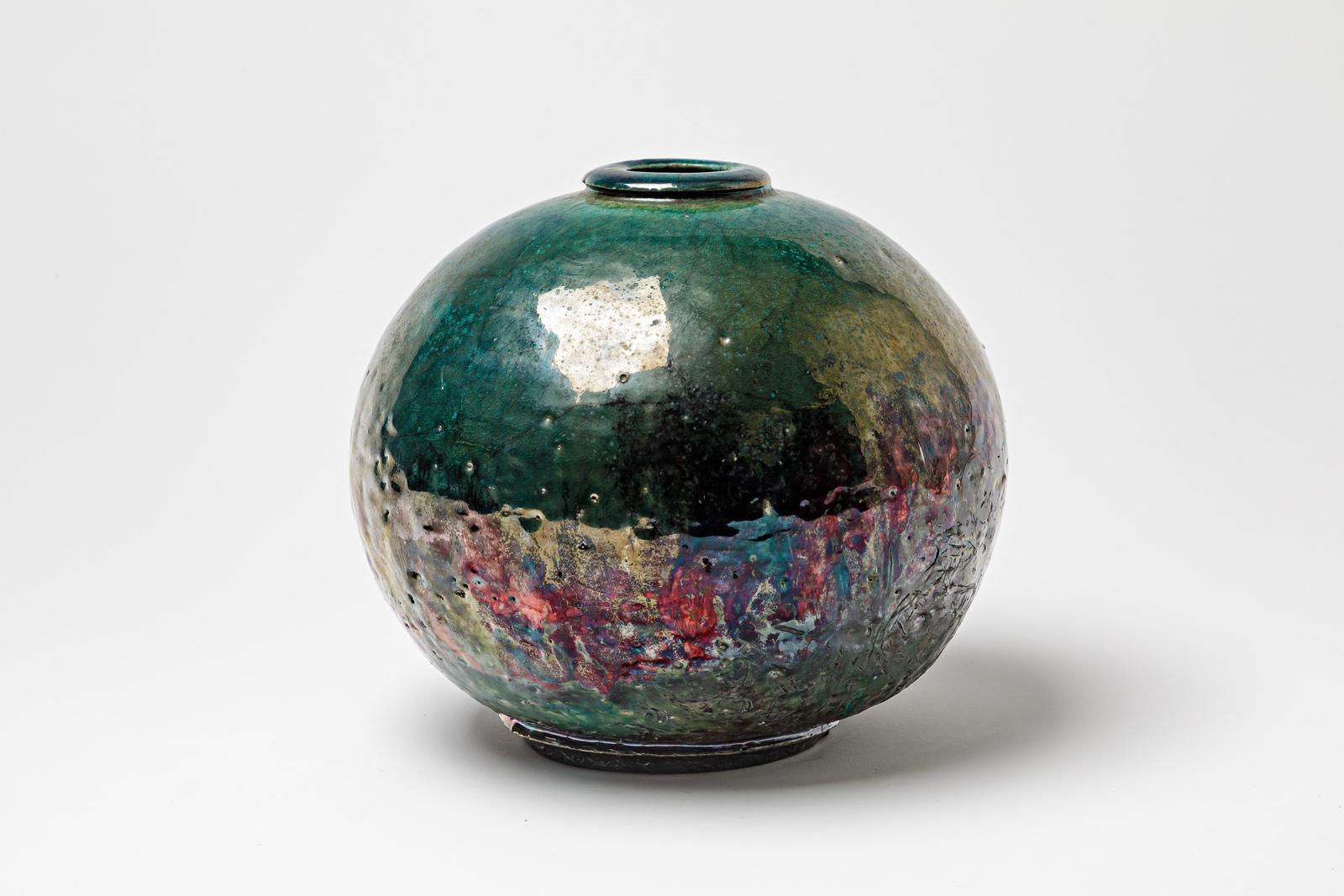 Vase en céramique émaillée verte à reflets métalliques de Gisèle Buthod Garçon. Raku a tiré. Monogramme et signature de l'Artistics sous la base. Vers 1980-1990. 
H : 7.9' x 7.9' pouces.