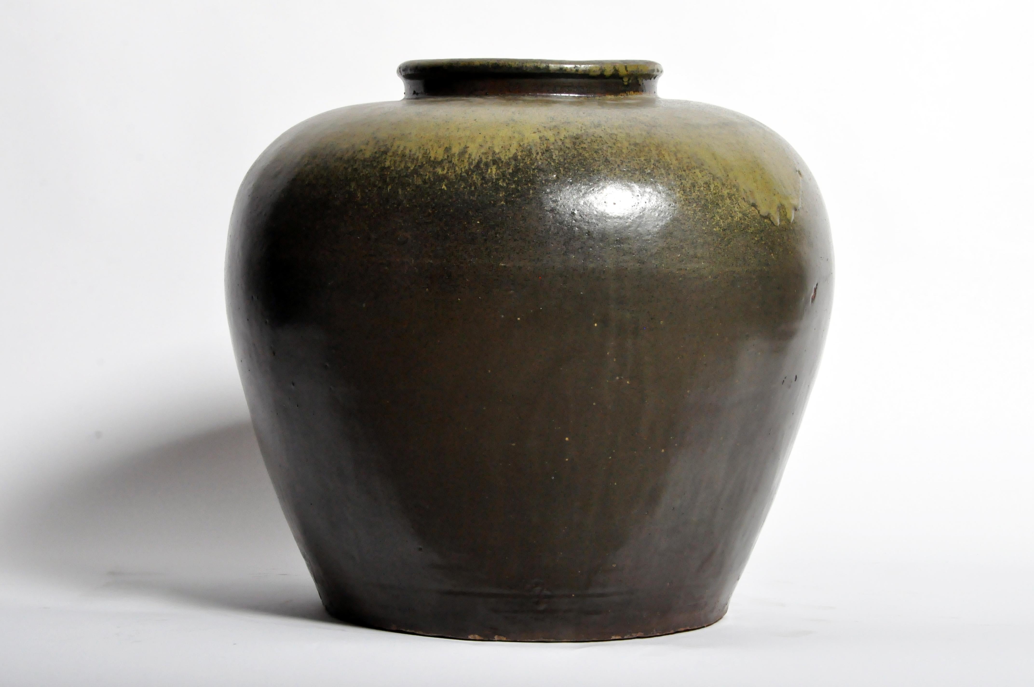 This green glazed pot is from China and was made from ceramic, circa late 1800s. Wear consistent with age and use.
 