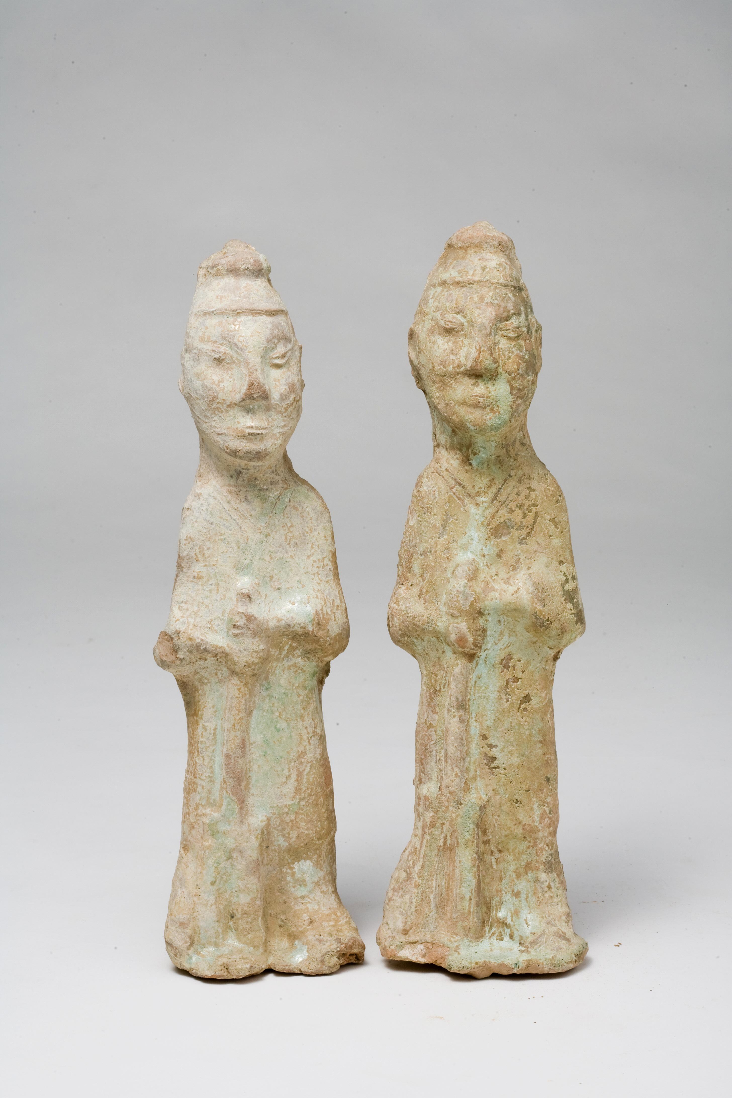 Han dynasty pottery tomb figure, modelled standing holding a Pitchpork in front of his body, covered in a turquoise-green glaze. These two pieces are believed to have been produced in the same era and kiln as the works referenced in The MET and the