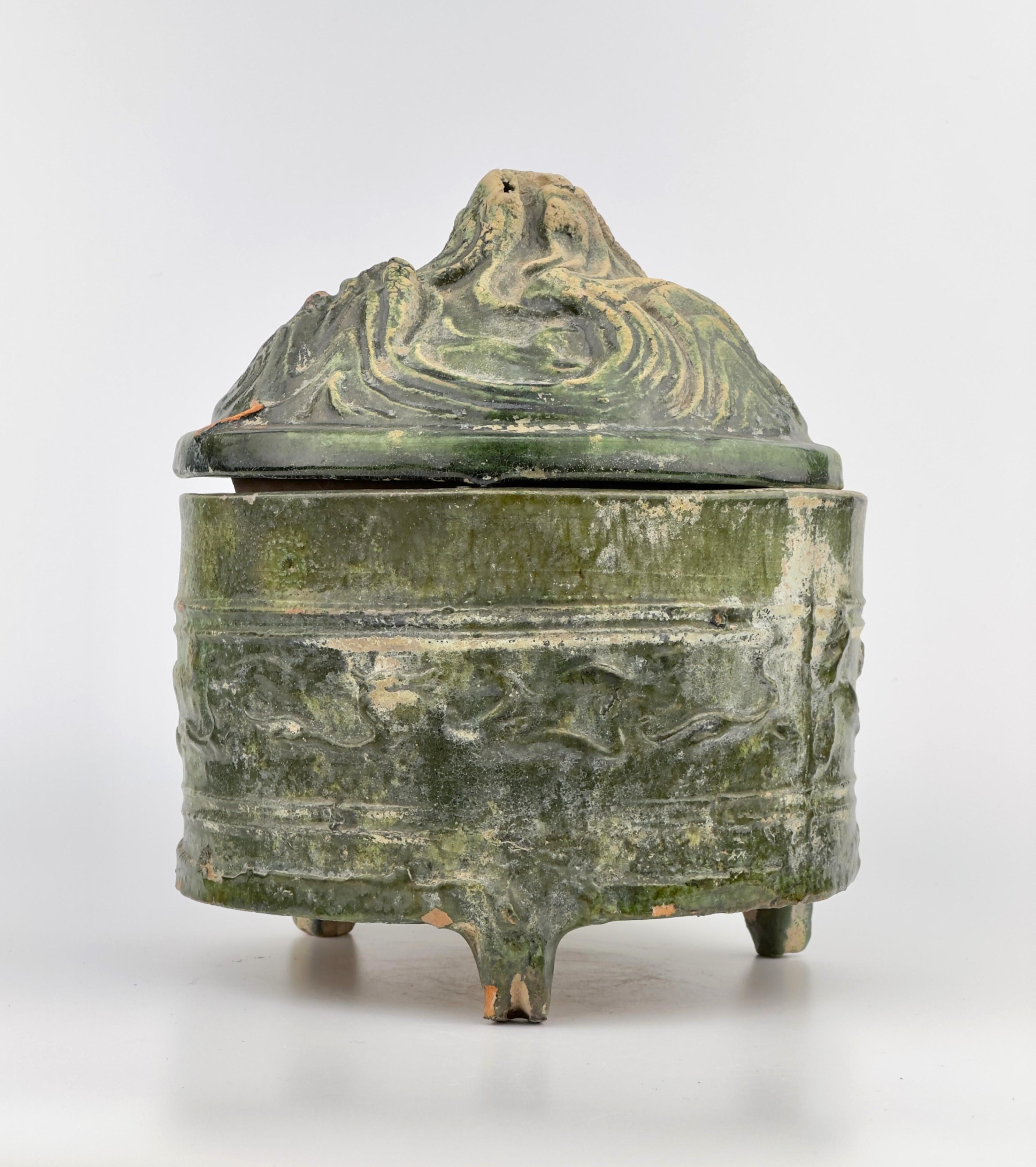 The modelled animal figures and landscapes of this piece represent the Daoist ideology of the Han dynasty. The mountain-shaped lid refers to the sacred dwellings of the immortals, the Kunlun mountains, which was ruled by the Queen Mother of the