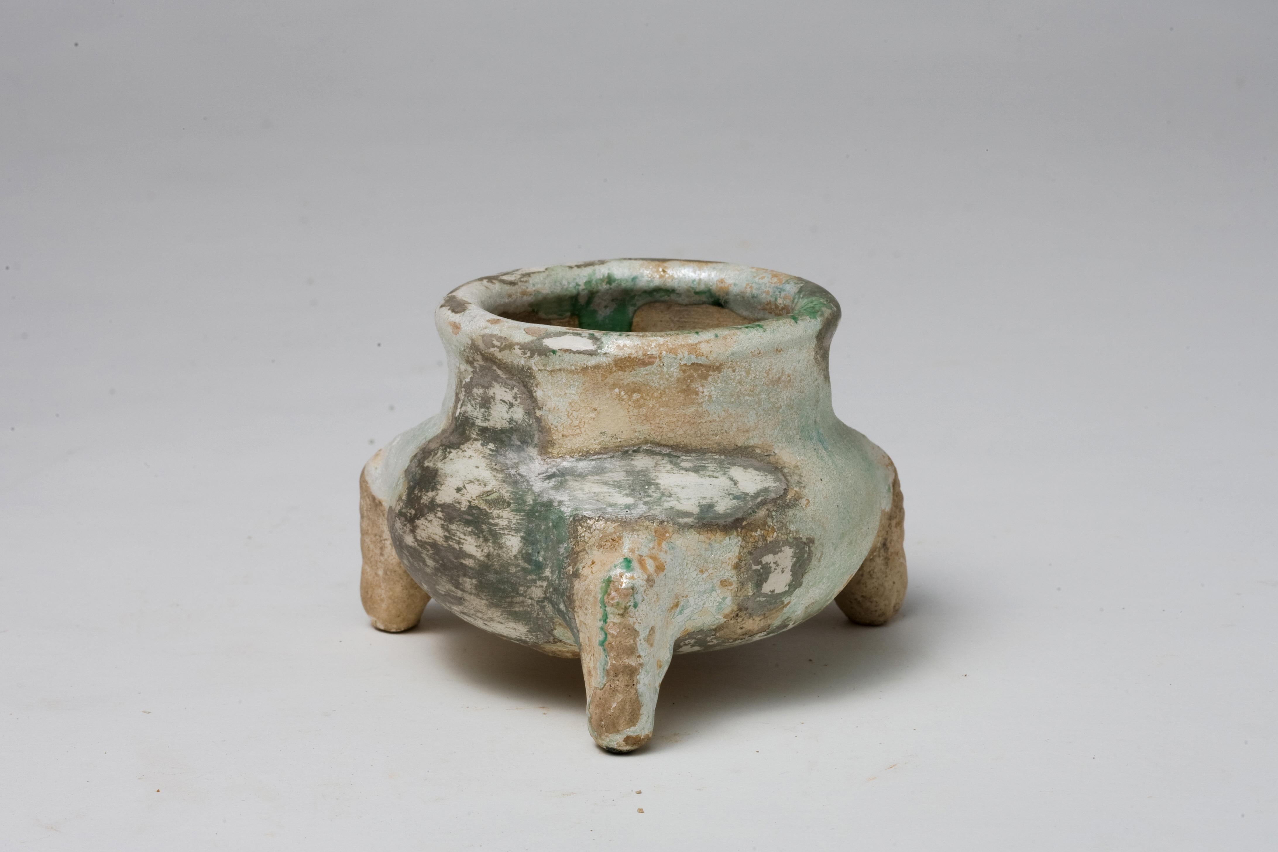 Han Dynasty green-glazed tripods are comparatively rare, especially ones that have retained their structural integrity and glaze over millennia. Pieces in good condition are scarce because they have often been buried with the deceased as part of