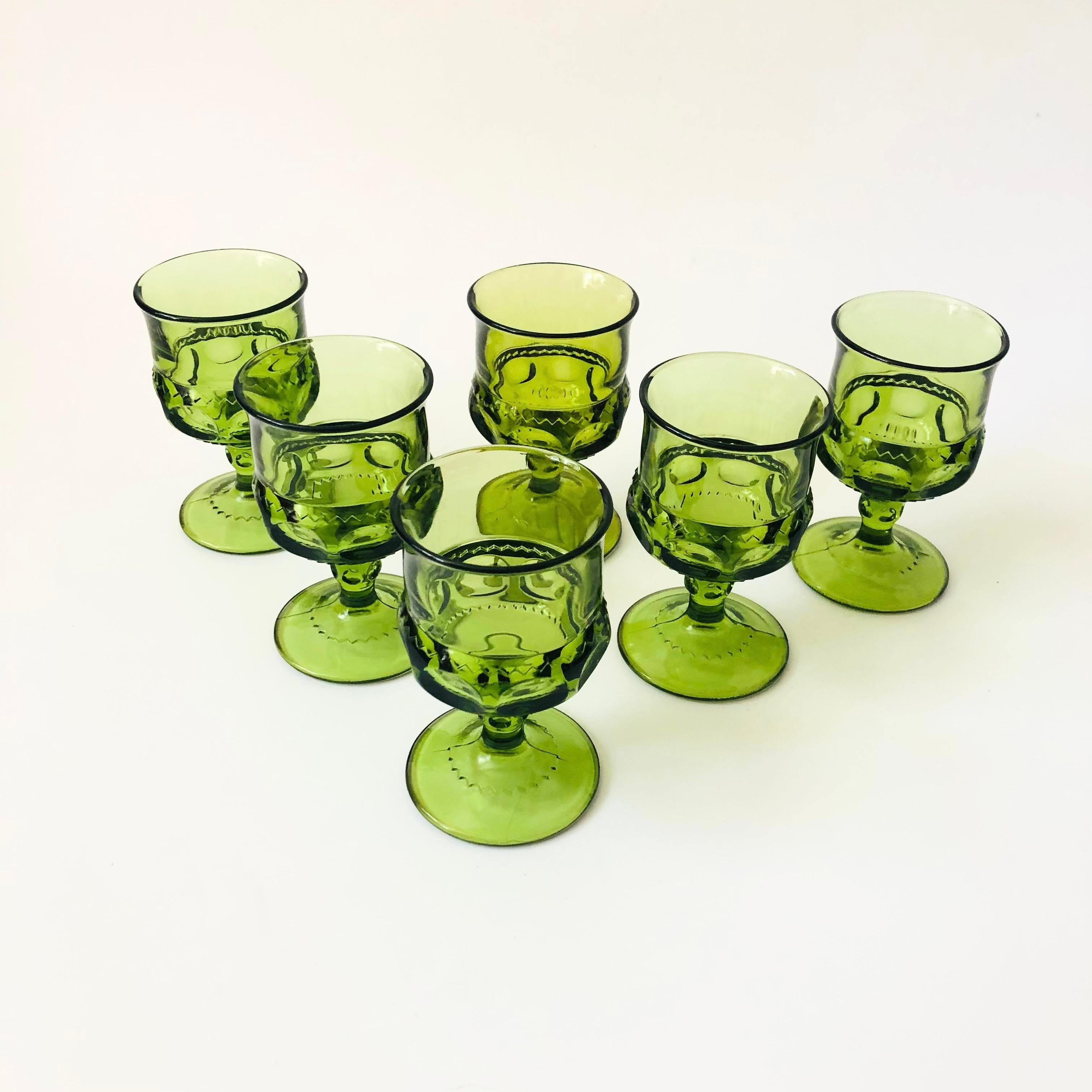 A set of 6 vintage goblets in an ornate design in green colored glass. Made in the King's Crown pattern by Indiana Glass. Perfect for a small glass of wine or champagne.

