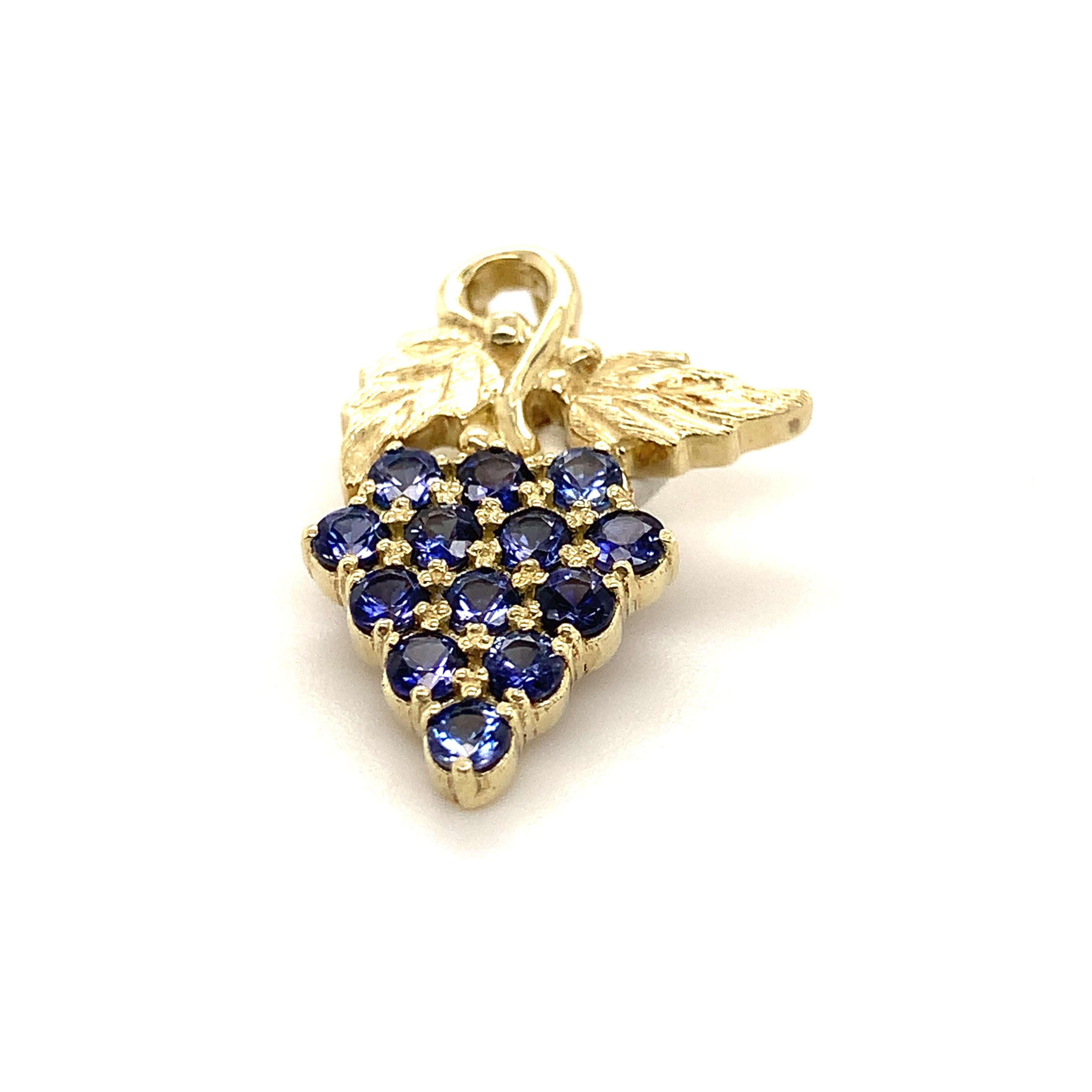 This smaller size grape pendant is done in 14-karat green gold to represent the leaves and the 13 Benitoites represent the grapes and weigh a total of 0.69 carats. 

Benitoite is the California State Gemstone and is one of the 10 rarest stones in