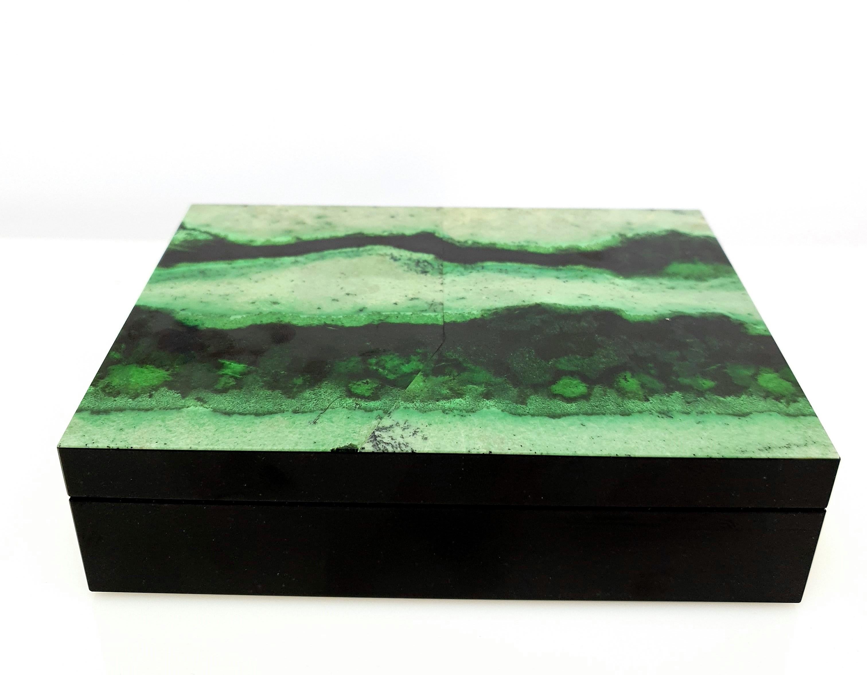 A Natural Handmade Green Garnet Grossular and Black Marble Decorative Jewelry Box.
The pattern looks like an artful painting of nature.

The Inlay is clad with cedar wood and is ideal as a cigar box.
Green Grossular belong to the Garnet family and