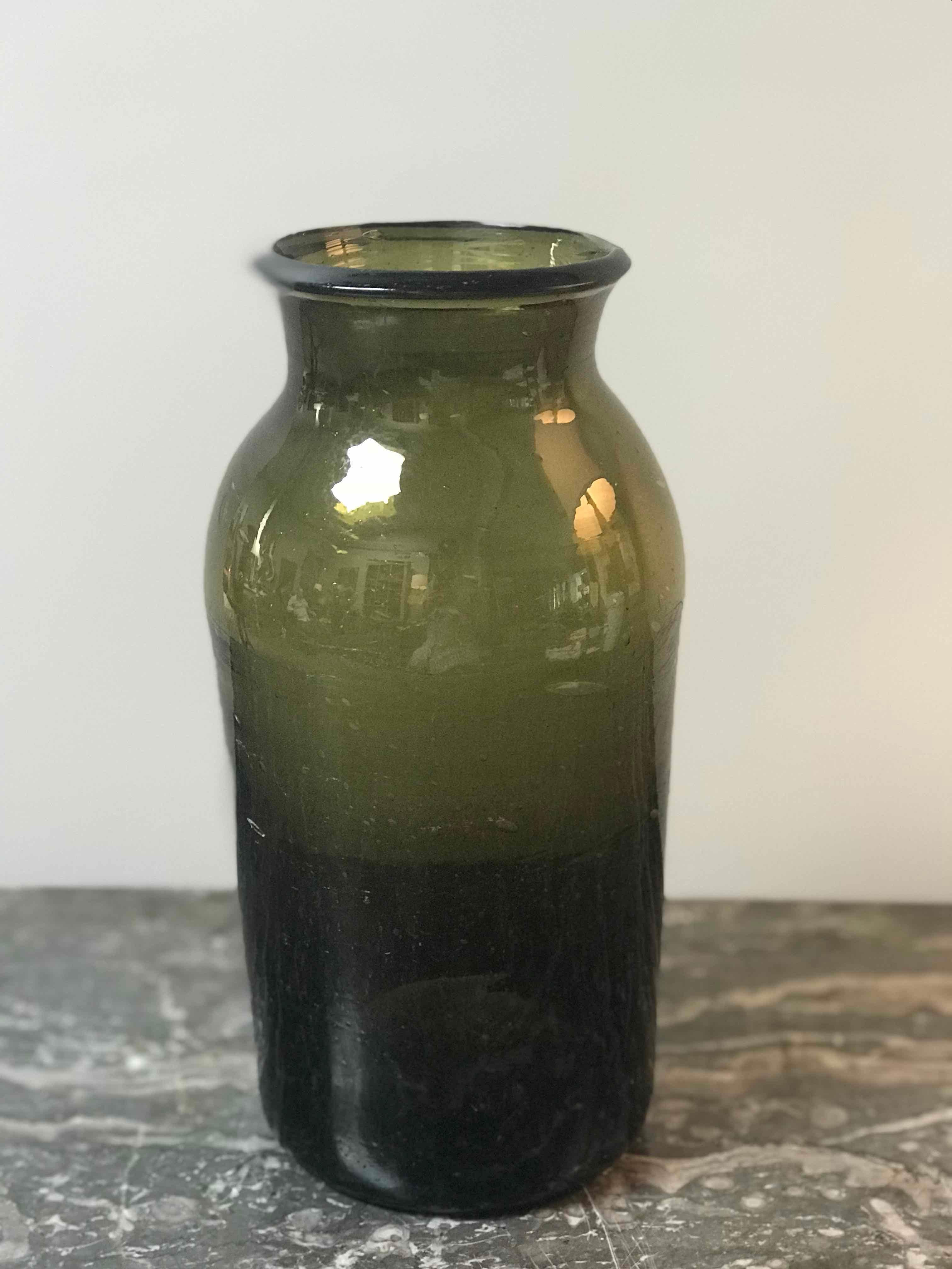 Green hand blown glass bottle from mid-19th century France. 