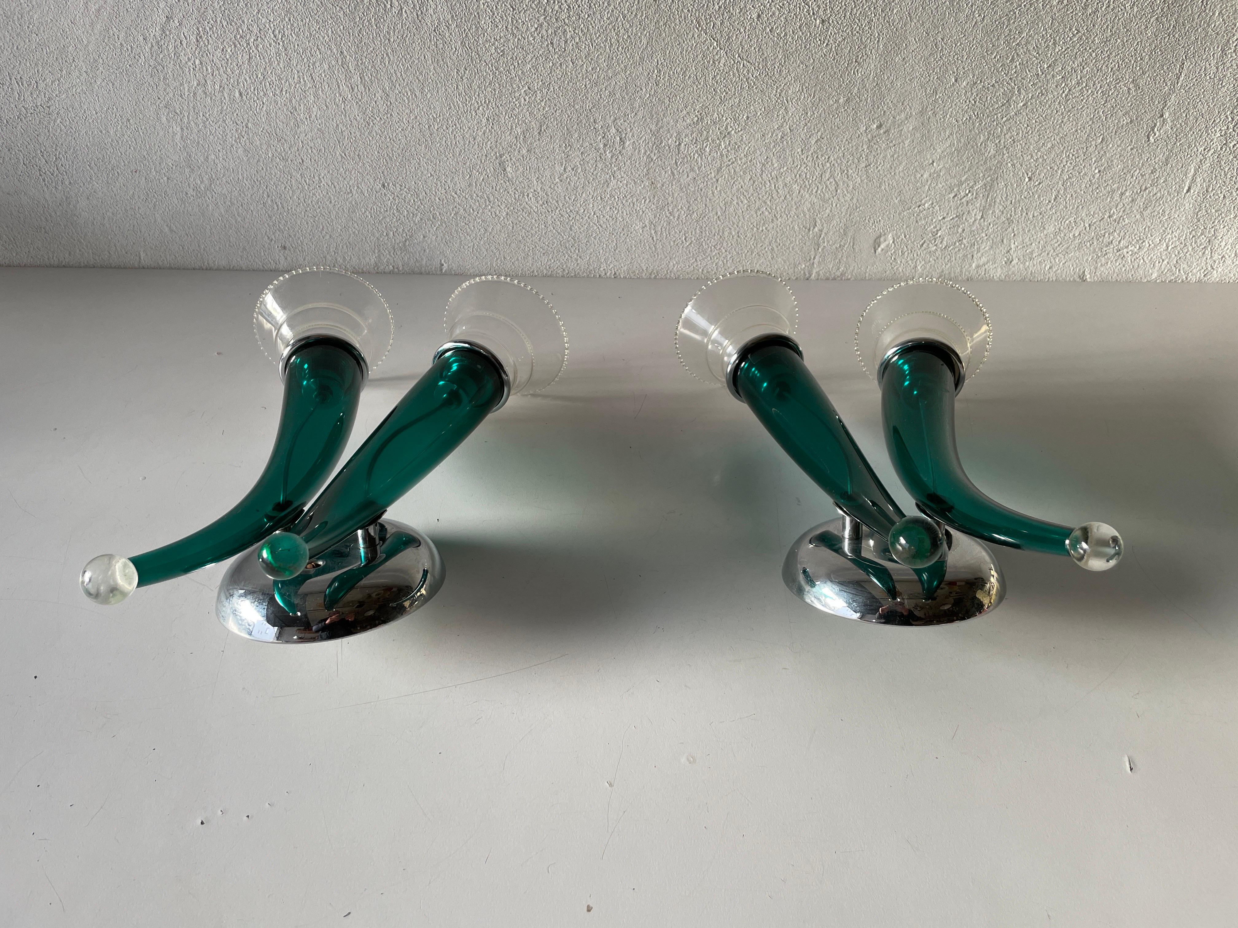 Green Italian handcrafted Semi-Transparent Murano glass pair of large sconces by VeArt, 1970s, Italy

Very elegant wall lamps
Lamp is in very good condition.

These lamps works with 2x E14 standard light bulbs. 
Wired and suitable to use in