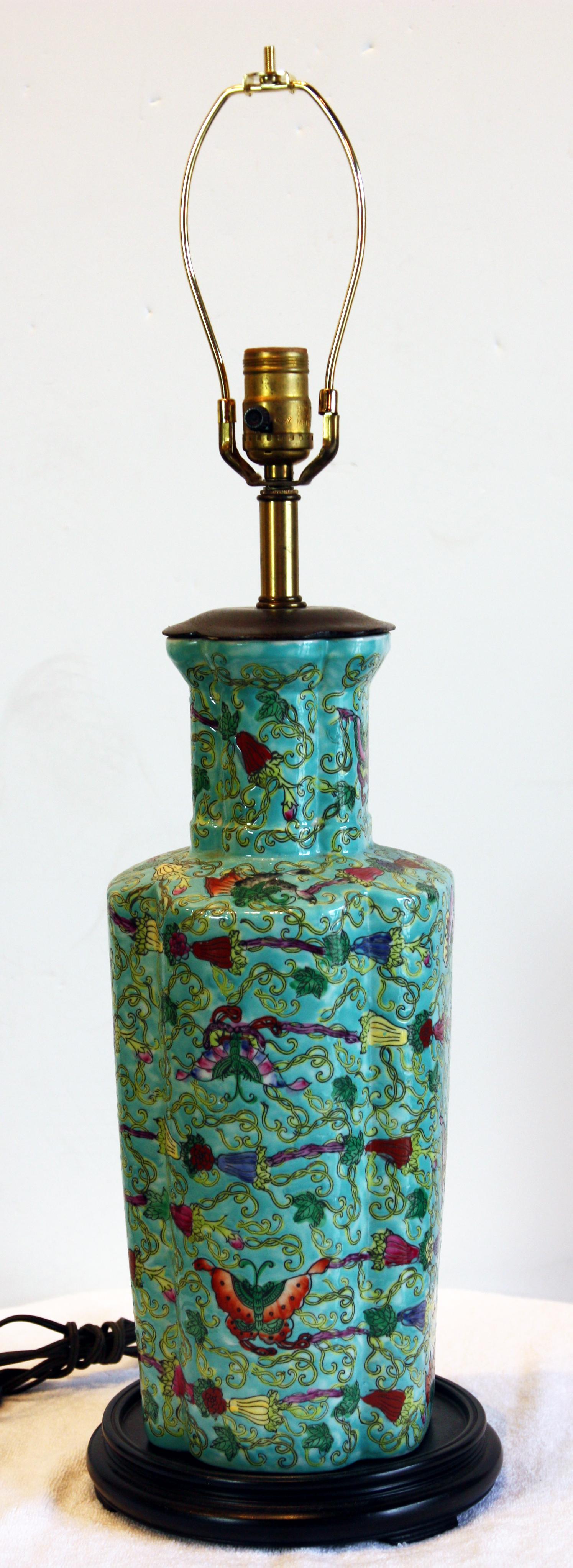 Green, hand-painted, Asian vase lamp on wooden stand. Adorned with flowers and butterflies. Shade included.