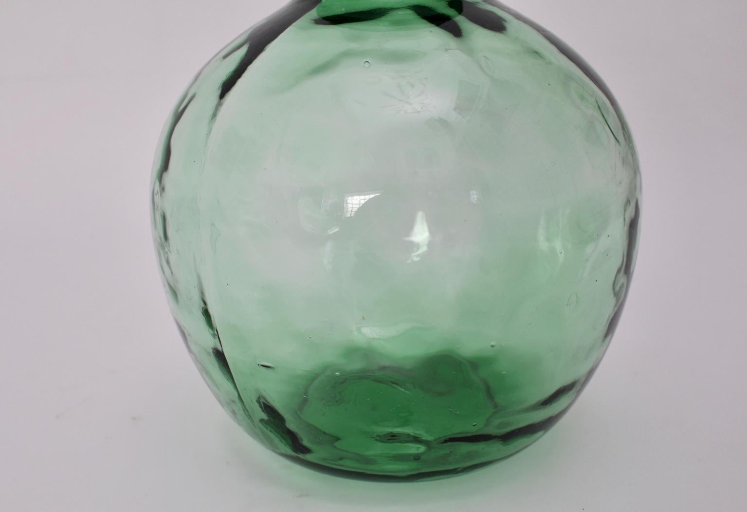 This presented green handblown very decorative glass bottle shows a 9 cm bottle opening. Also the glass bottle features bubbles in the glass.
Marked with Viresa.
There are no spots or damages, so the green clear glass bottle is in best vintage