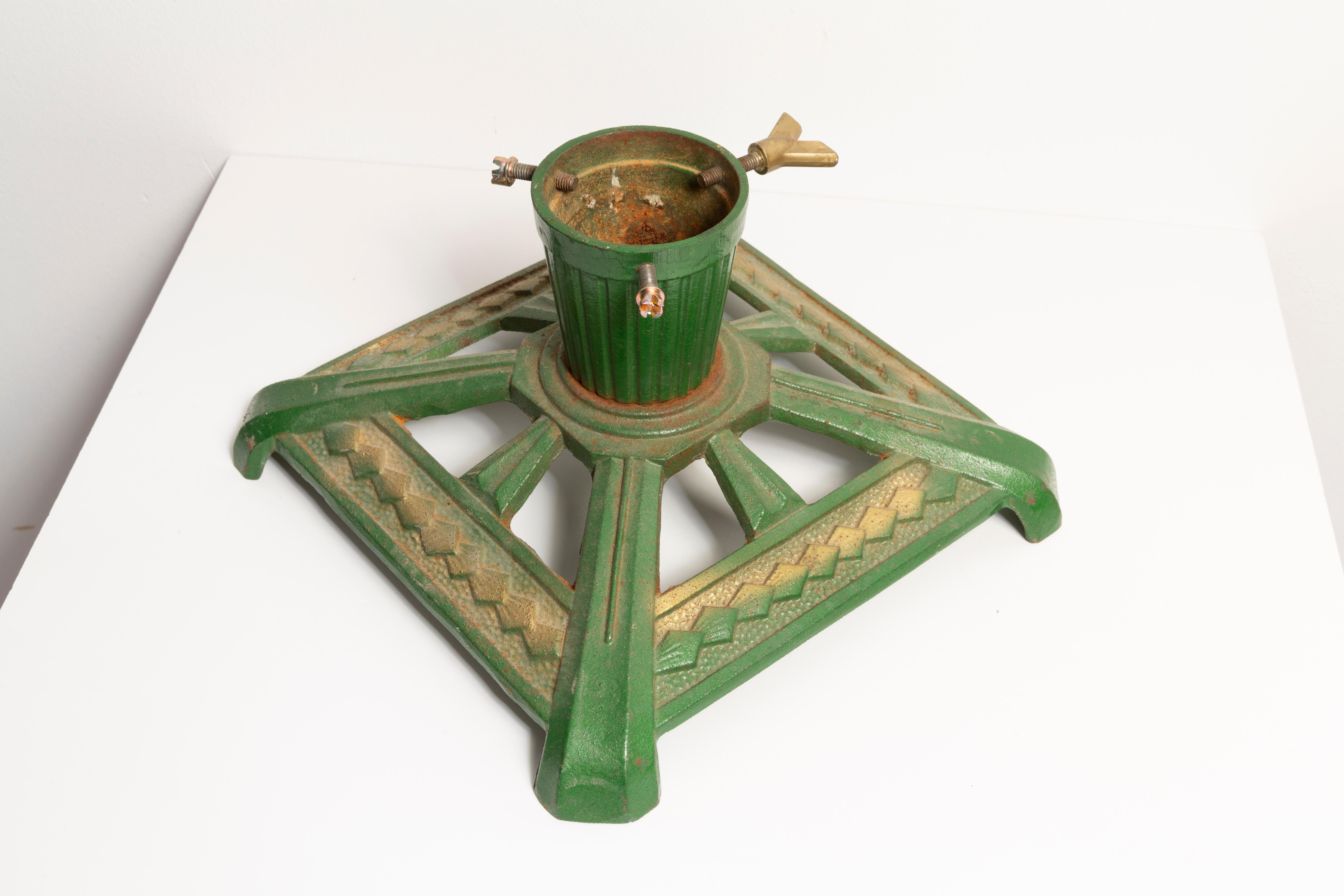 This early 20th century, cast iron Christmas tree stand is especially crafted for small Christmas trees. It is perfectly Art Deco in shape and it is ideal for displaying a Christmas tree in a shop window, on a table or on the floor, but made for
