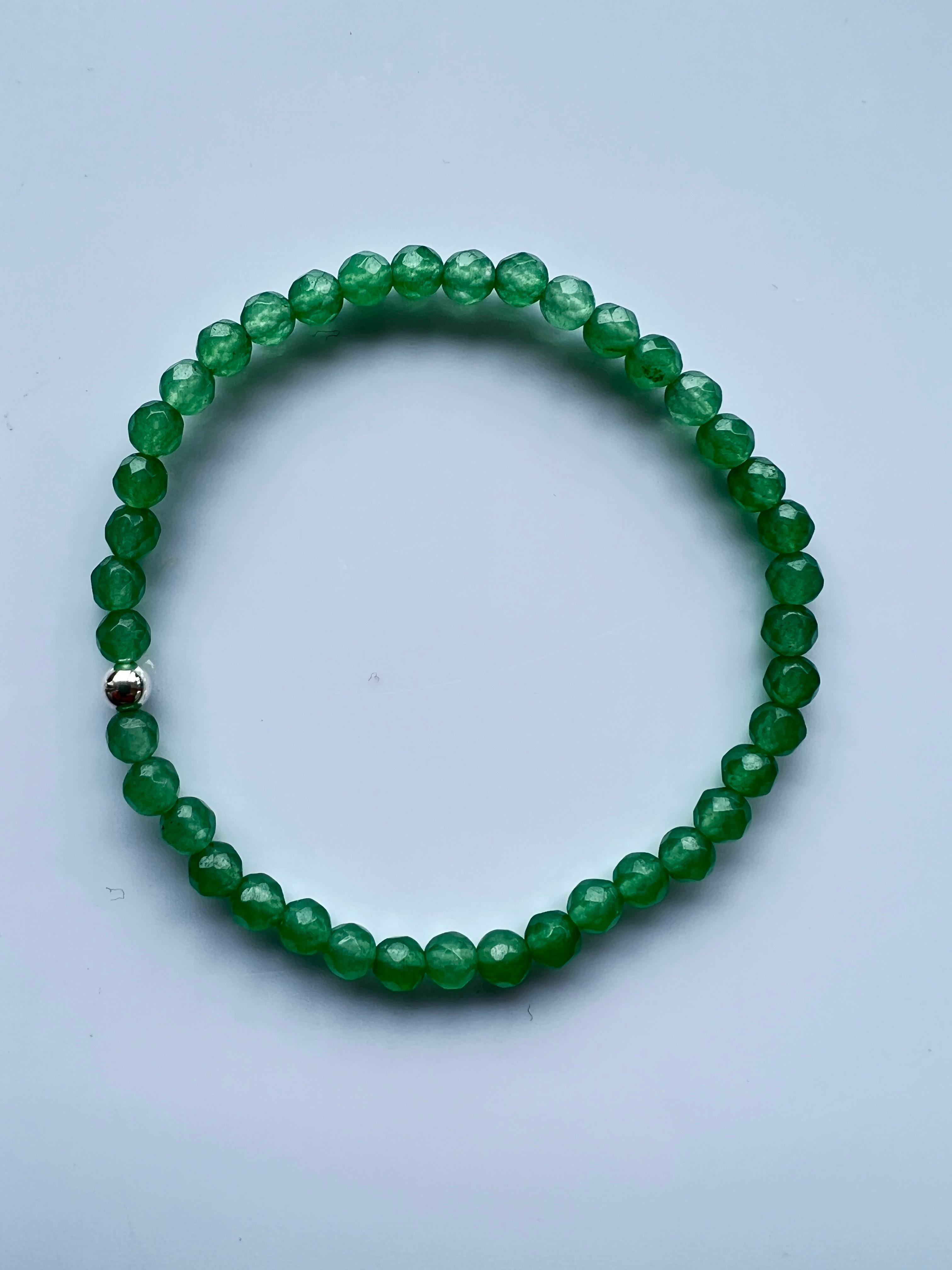 Green Gem Heart Chakra Beaded Bracelet Natural Semi Precious Gem Silver J Dauphin

Introducing the J Dauphin Green Stone Beaded Bracelet, an exceptional piece of jewelry radiating a serene ambiance and profound spiritual significance. Each bracelet