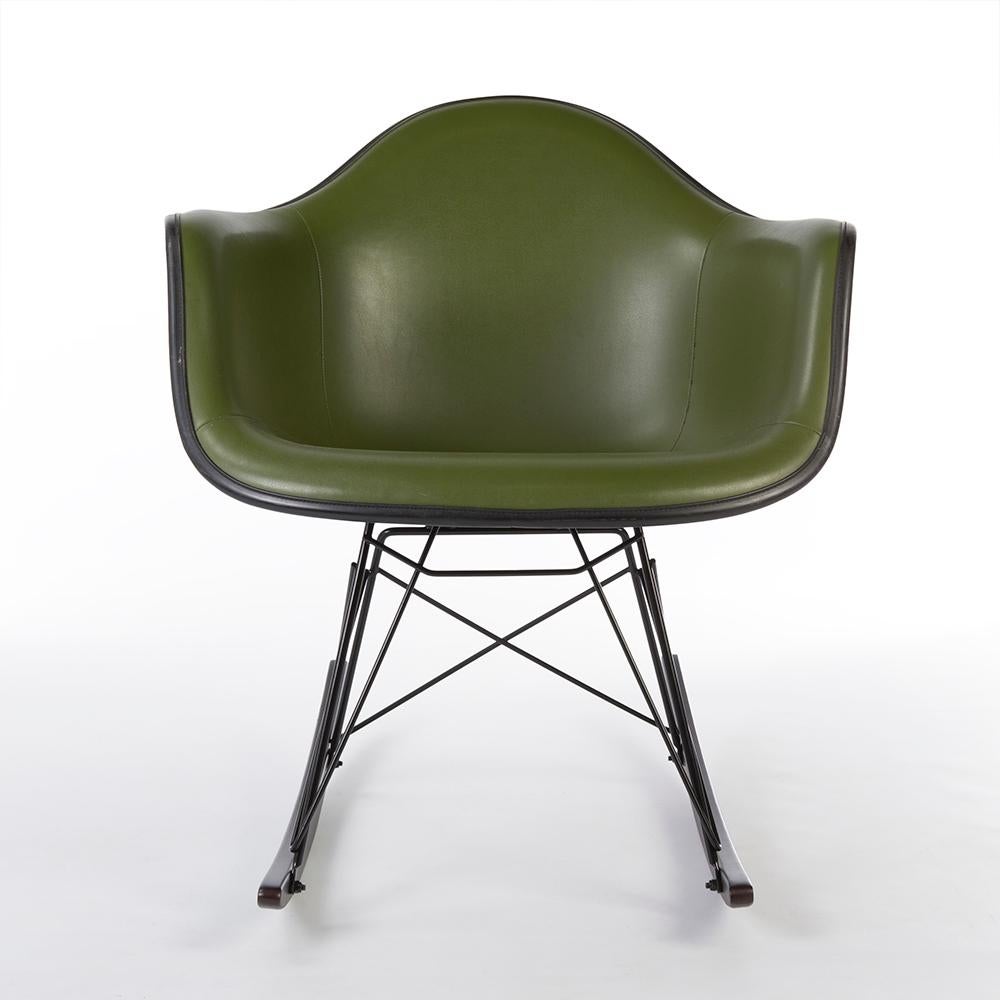 A vintage Herman Miller black Eames arm shell with stunning green Alexander Girard designed vinyl upholstery and a new walnut RAR base is a great blend. The arm shell is in good condition for its age though it does display some slight cuts in the
