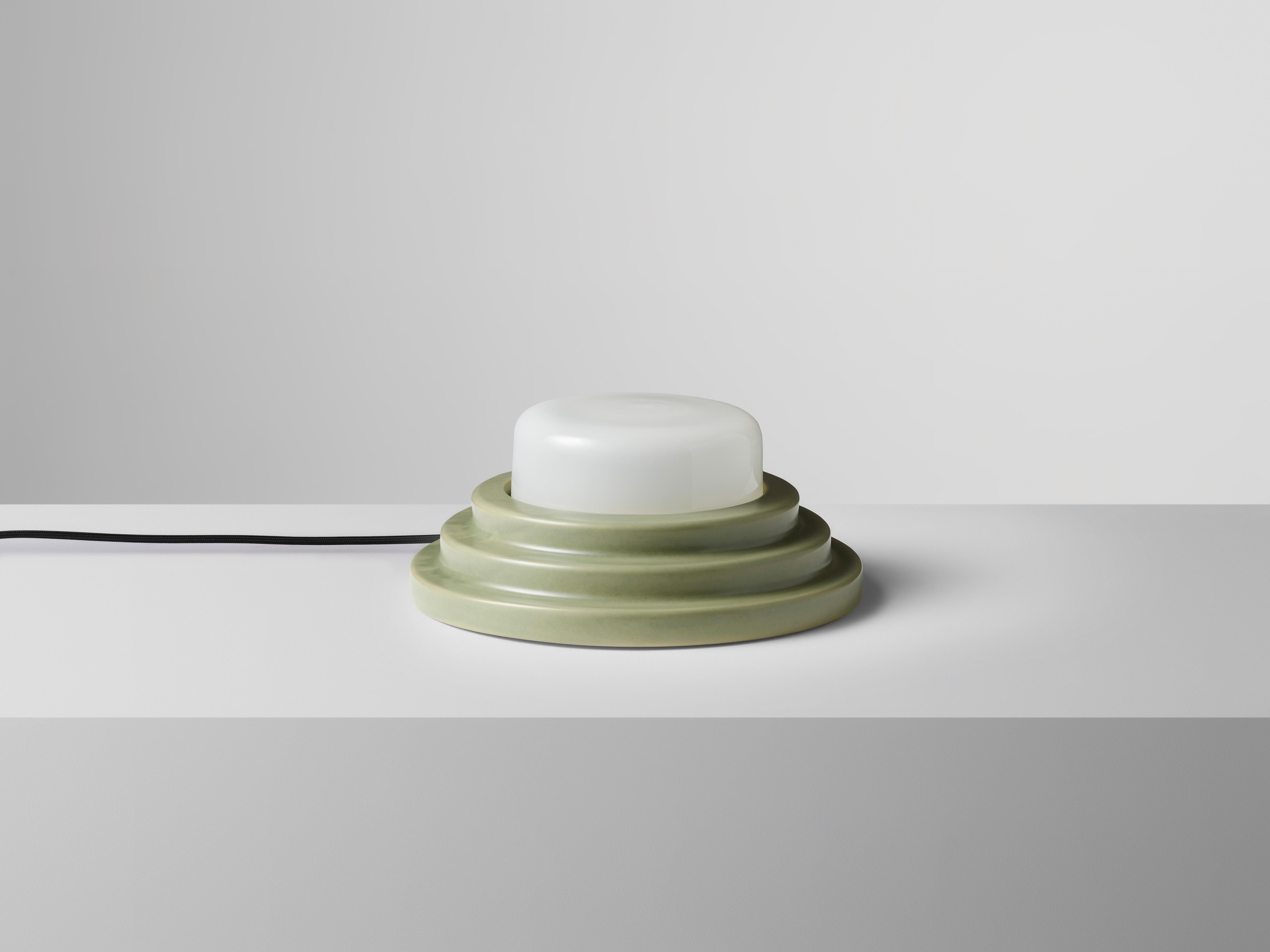 Green Honey Table Lamp by Coco Flip
Dimensions: D 30 x W 30 x H 12 cm
Materials: Slip cast ceramic stoneware with blown glass. 
Weight: 4kg

Standard fixtures included
1 x ceramic G9 lamp holder
1 x dimmable 3.5W 3000K (warm white)
G9 LED globe 300