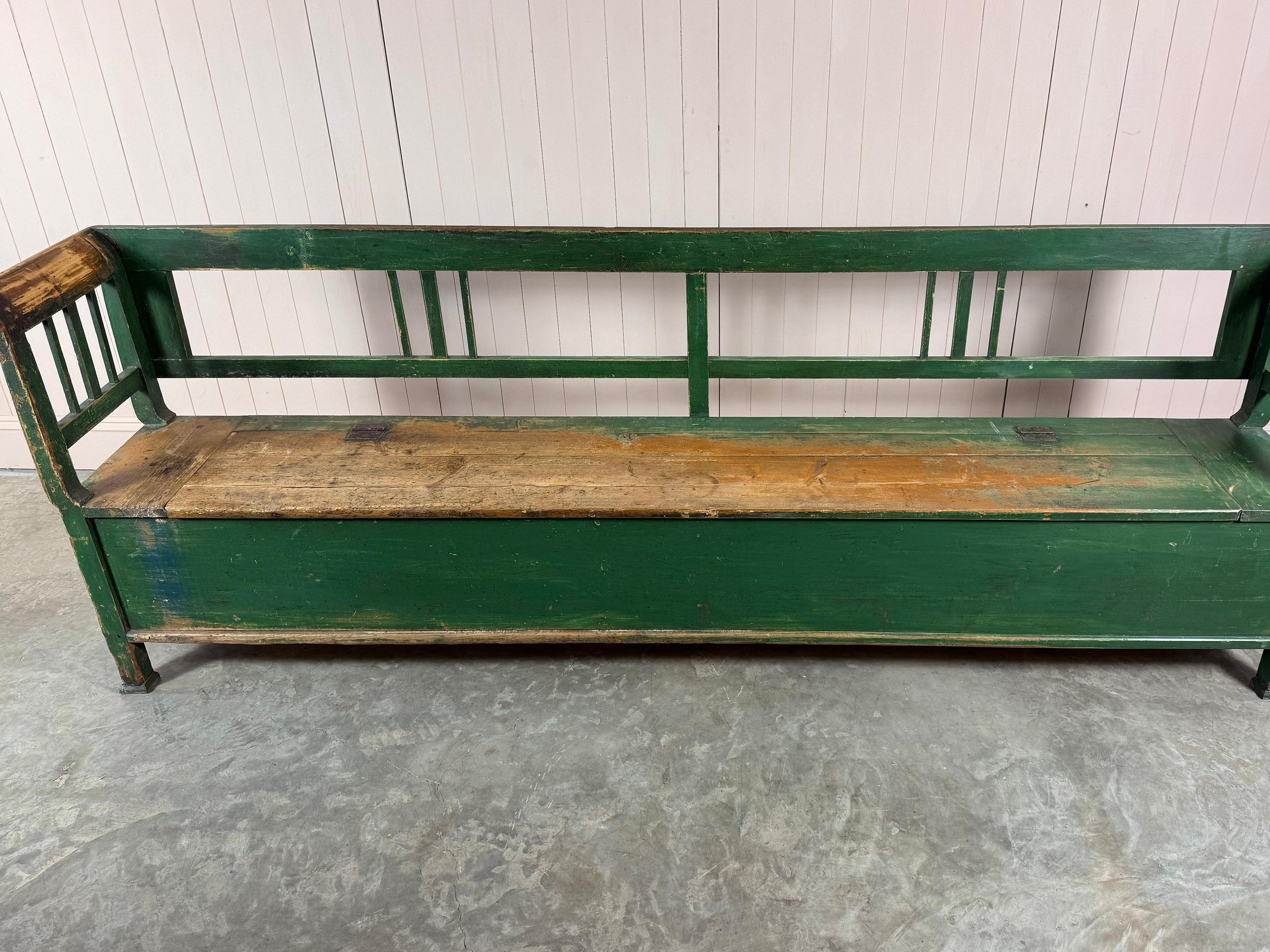 This Hungarian settle or box bench is a fine example of Central European rural craftsmanship. Handcrafted from solid pine it combines rustic charm and history with practical utility. Early 20th Century this storage bench originated from the rural