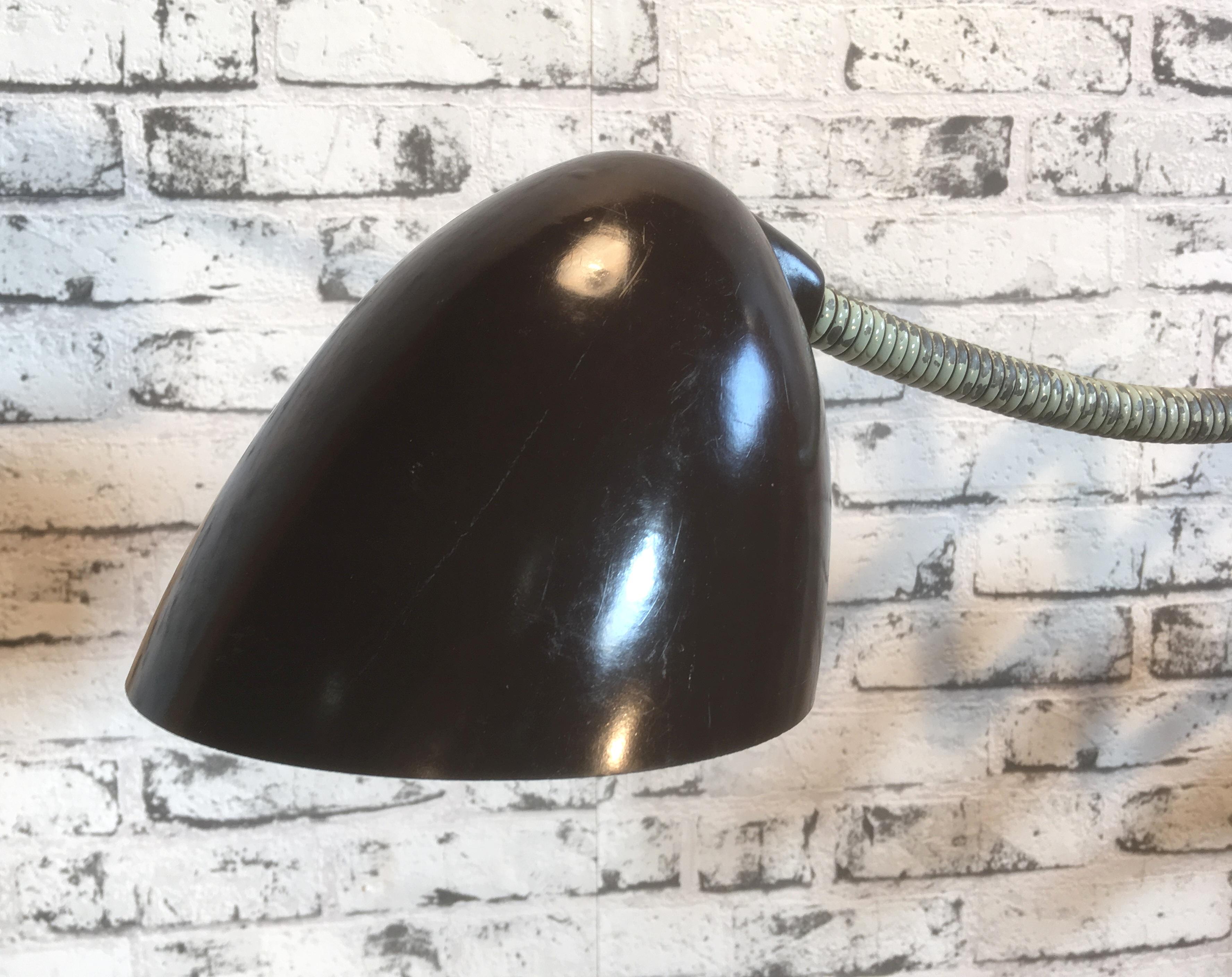 This vintage Industrial scissor lamp was produced by Elektroinstala in former Czechoslovakia in the 1960s. Lamp has brown Bakelite shade. Green iron scissor arm is extendable and can be turned sideways. Fully functional. Very nice vintage