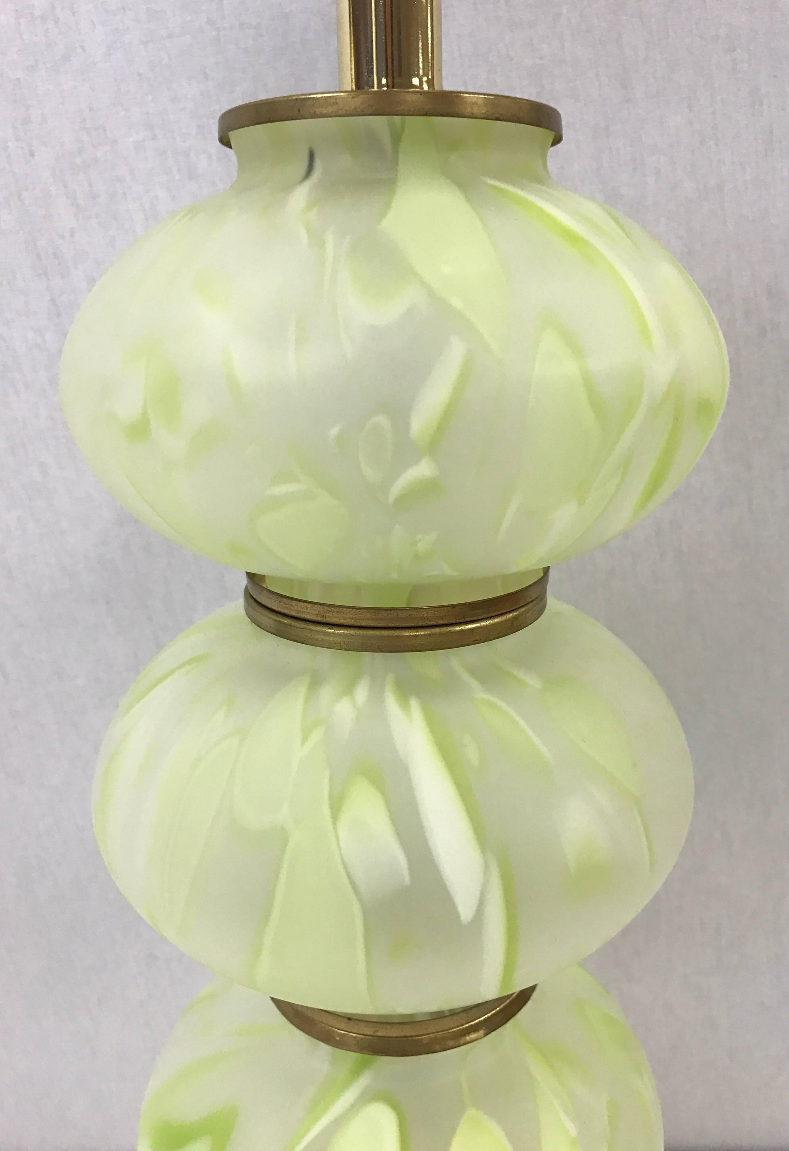 Pair of matching Murano glass globe lamps in a stunning combination of light green and cream glass. Height to top of socket is 22 inches. Overall height with harp is 29 inches. The chic green color makes these a must have!