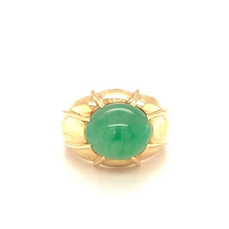One green jadeite jade 18K yellow gold ring centering one oval cabochon jade weighing approximately 16 ct. (14.05 x 12.07 x 10.93 mm.) with Mason-Kay lab certificate stating Grade-A jade. Puffed and lined yellow gold mount. Circa 1970s.

Commanding,
