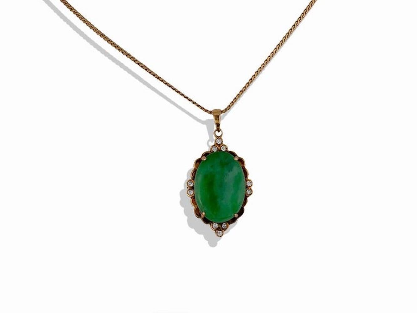 Asian jade and diamond pendant is made with a natural oval cabochon  jade measuring 19.5 x 13.5 x 4mm. 
The jade is set in an 18 karat yellow gold setting and has 10 round brilliant diamonds accenting the jewel-green colored center piece. 
The
