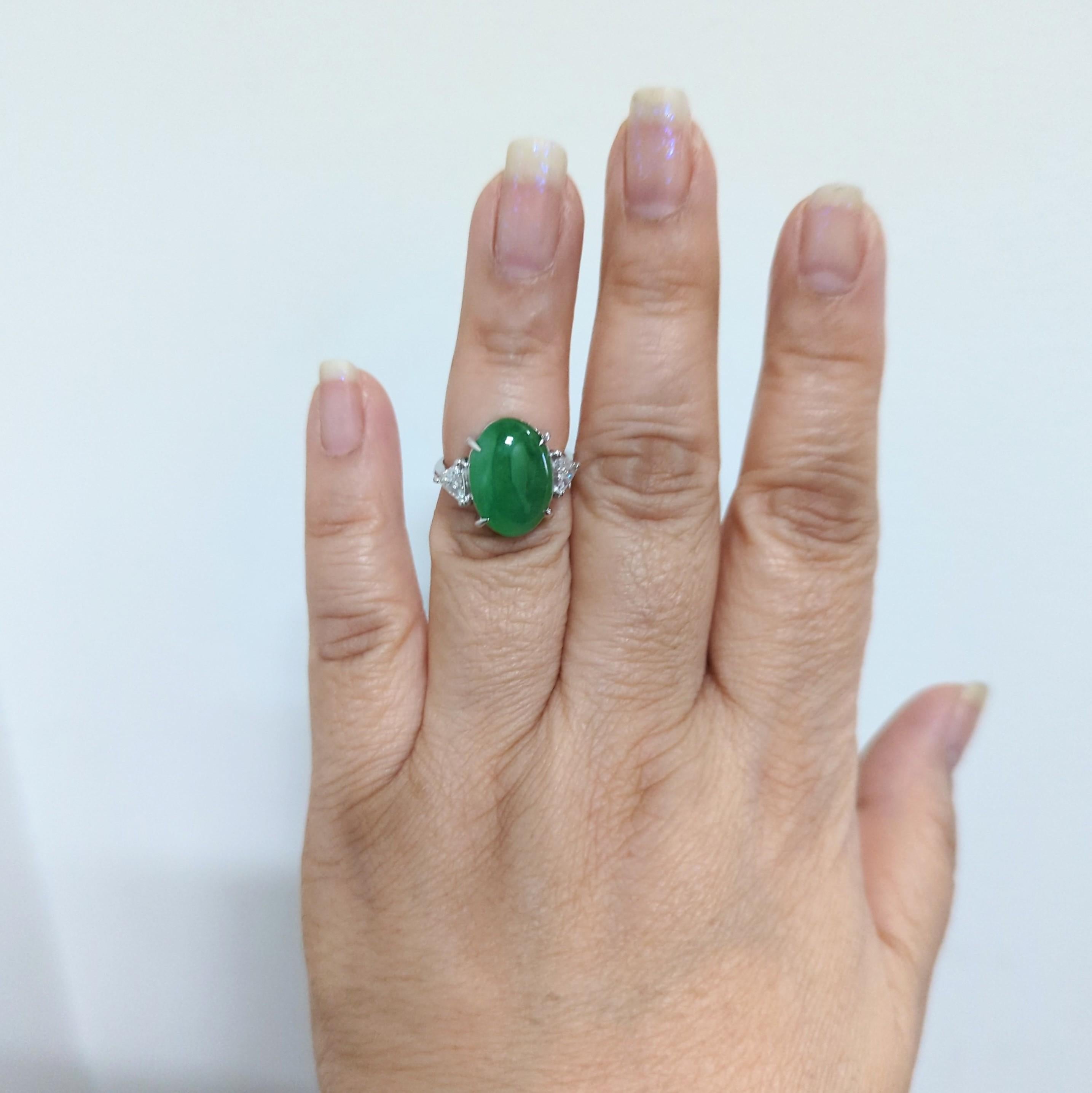 Beautiful 7.90 ct. green jade oval cabochon with 0.50 ct. good quality white diamond trillions.  Handmade in platinum.  Ring size 6.