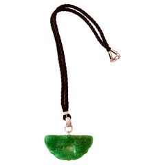 Green jade half circle shaped carved pendant with diamonds in silk cord