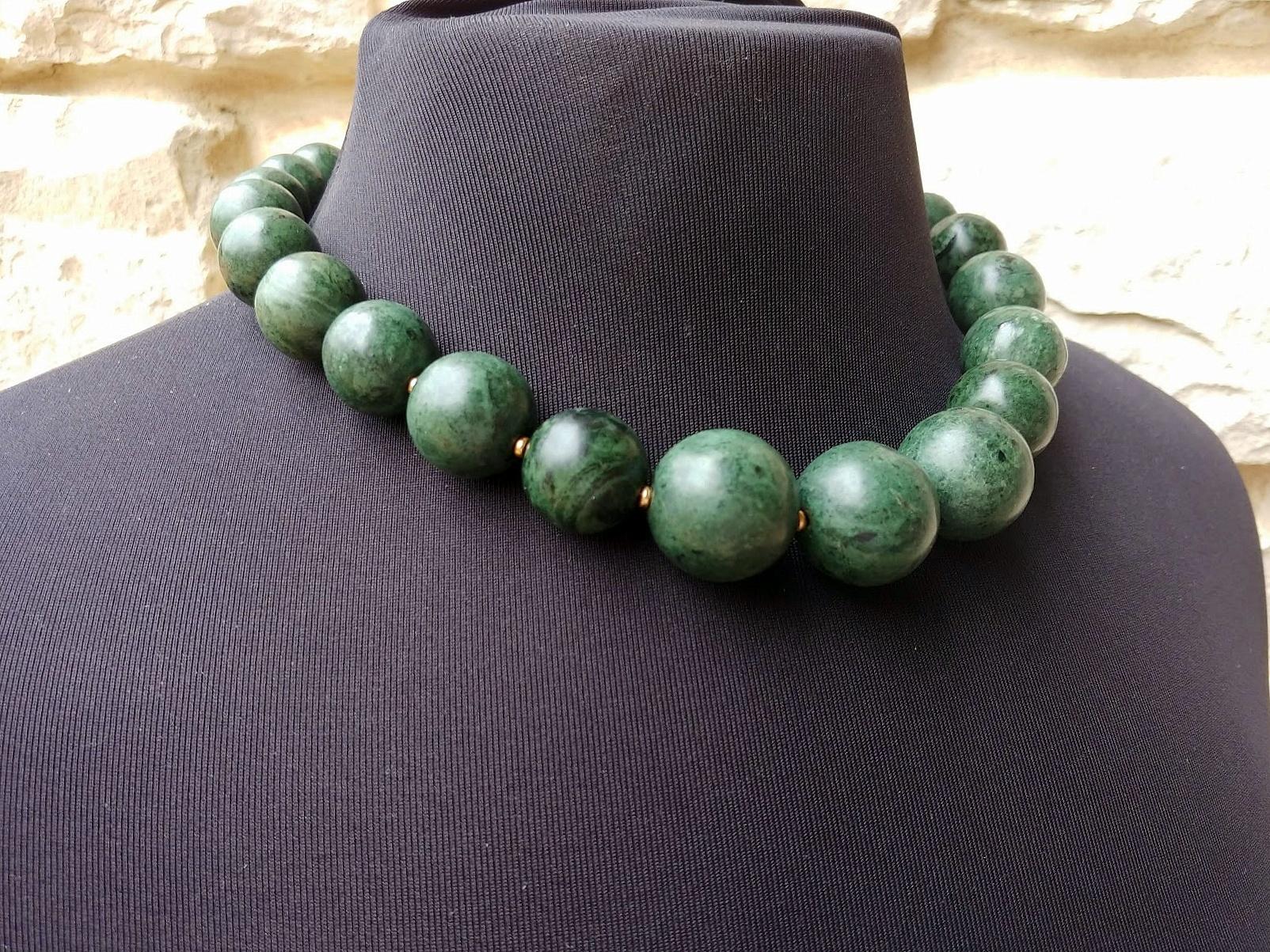This Green Nephrite is from the Eastern Pamir. Unique and very rare nephrite! 

The necklace is 19 inches (48 cm) long, and the beads' sizes vary from 15 mm to 23 mm. 
Nephrite beads are nontranslucent.
The color of the beads is deep dark green.
The