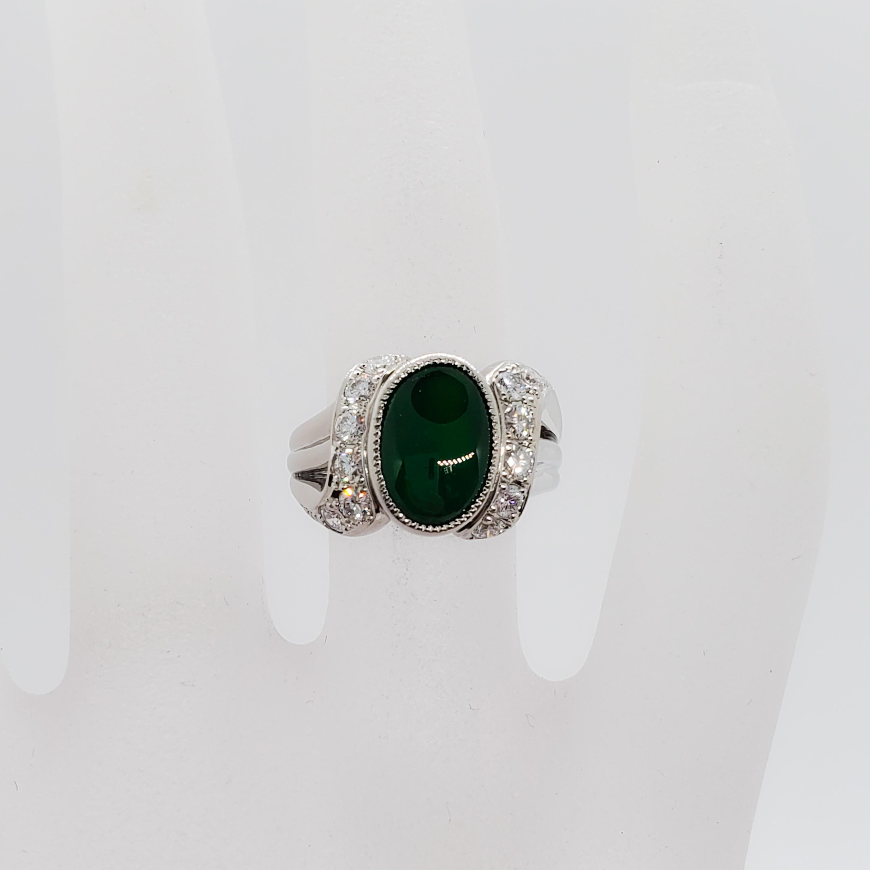 Beautiful deep green 3.10 ct oval cabochon jade with 0.48 cts of white and bright diamond rounds in a handmade platinum mounting. Ring size is 5.75 with approximately 9.50 grams of metal. Excellent condition.
