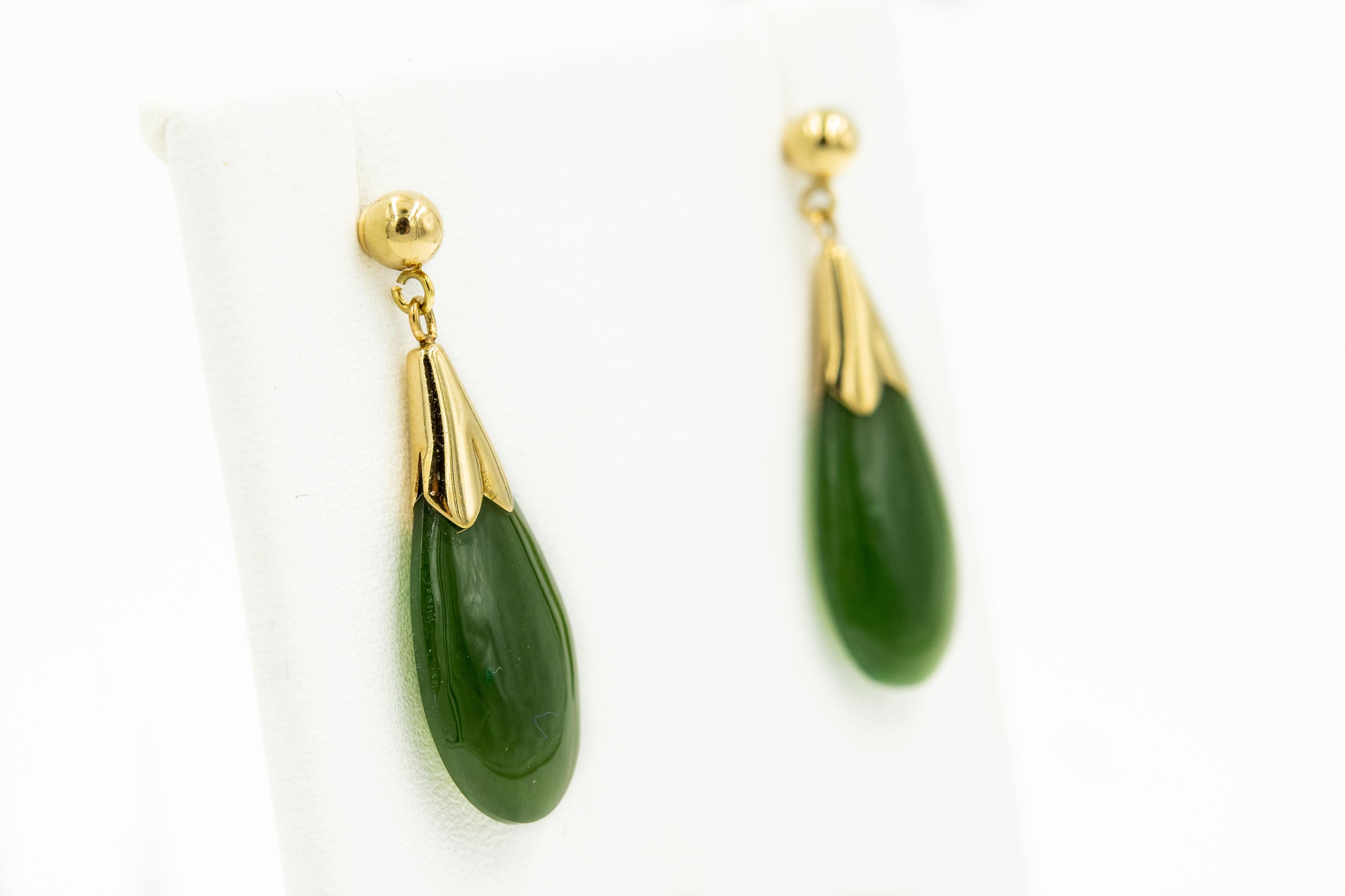 Elegant green nephrite jade teardrop dangling from a 10k yellow gold ball.  These earrings have posts and the push on backs are 14k.