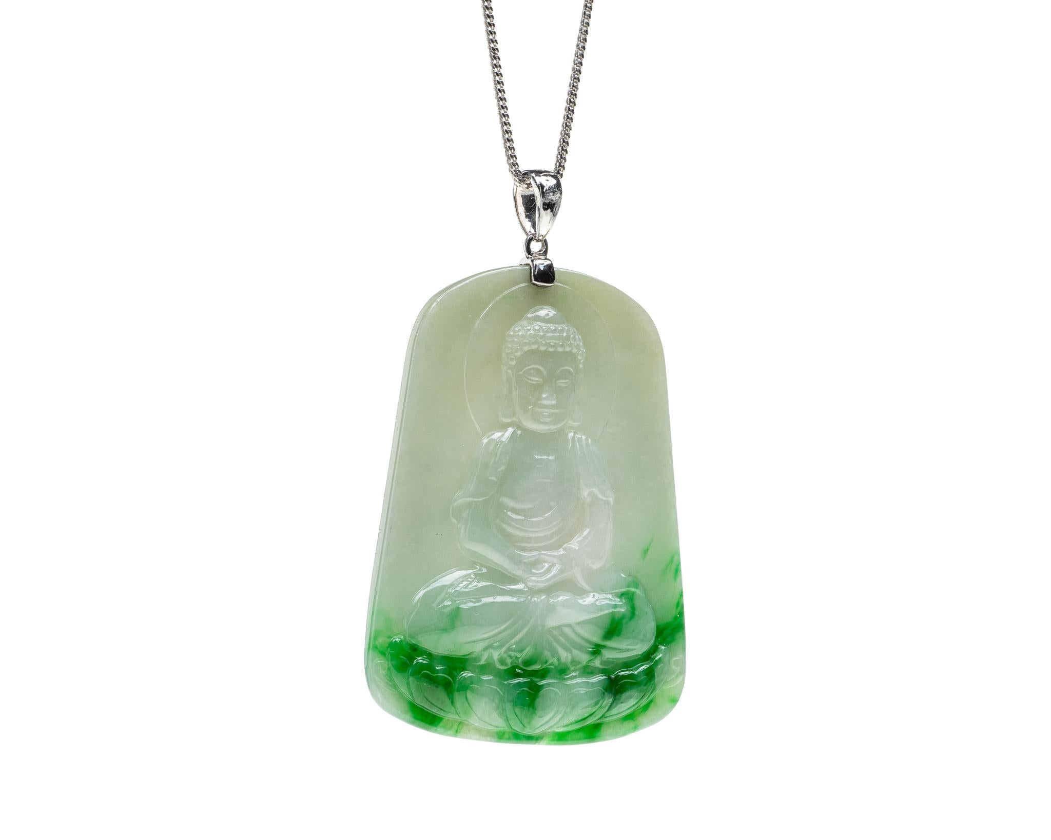 This is an all natural, untreated green jadeite jade carved happy buddha and set on an 18K white gold and diamond bail.  The carved happy buddha symbolizes happiness, compassion and protection.   
 
It measures 1.95 inches (49.7 mm) x 1.46 inches