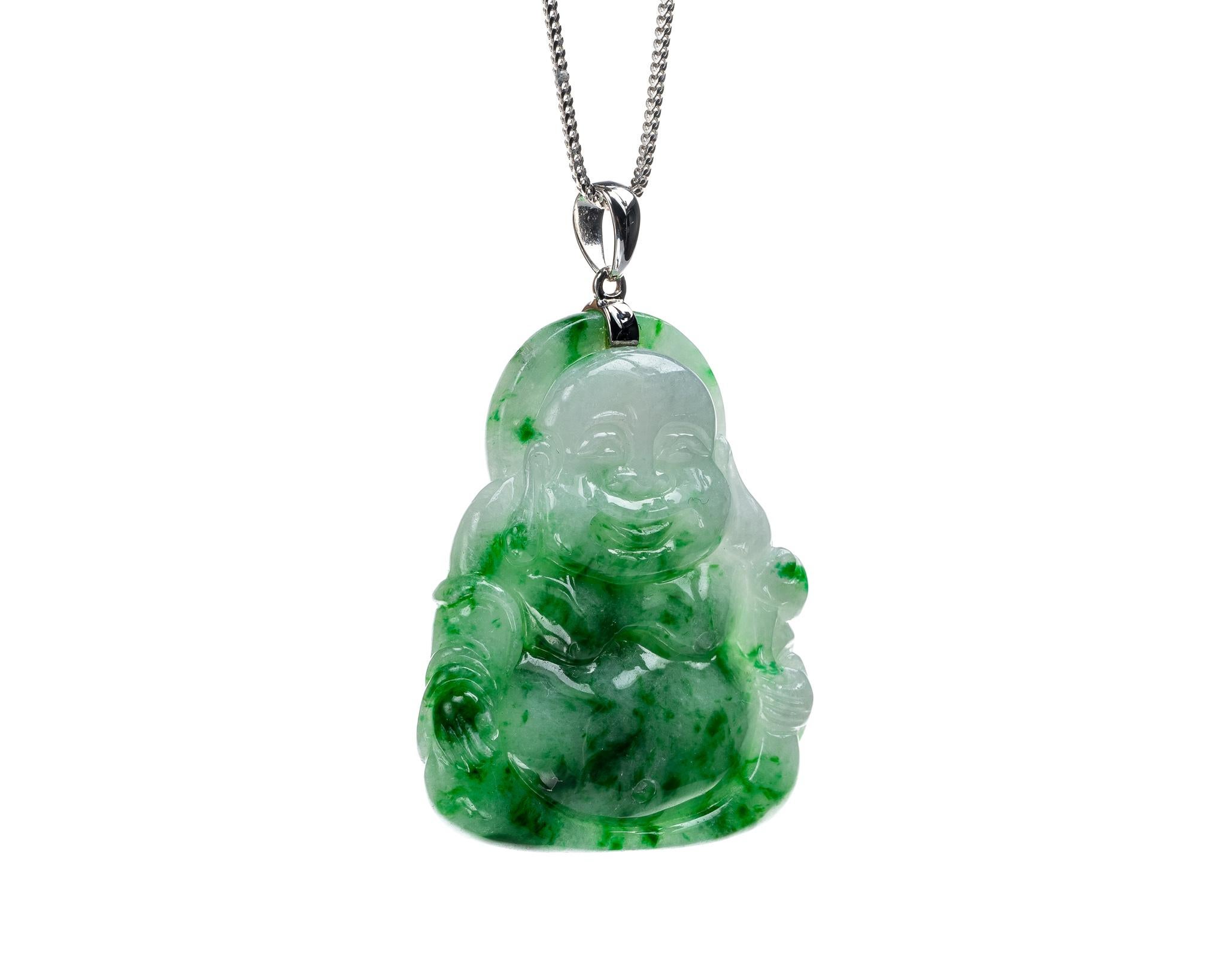 This is an all natural, untreated jadeite jade carved buddha pendant set on an 18K white gold bail.  
   
It 1.26 inches (32.2mm) x 1.51 inches (38.5mm) with thickness of 0.26 inches (6.7mm) weighing 16.2 grams. 

Included is a Hong Kong Gems