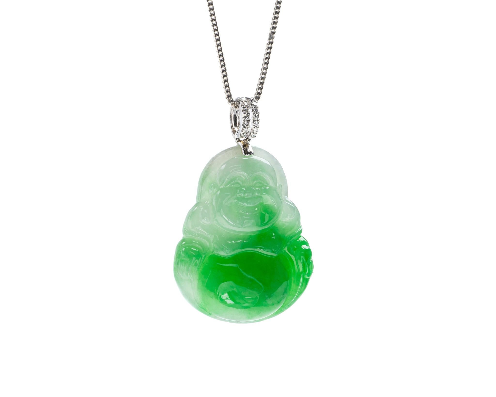 This is an all natural, untreated jadeite jade carved happy buddha pendant set on an 18K white gold and diamond bail.  The carved buddha symbolizes peace and compassion.
   
It measures 0.97 inches (24.8 mm) x 1.48 inches (37.7 mm) with thickness of
