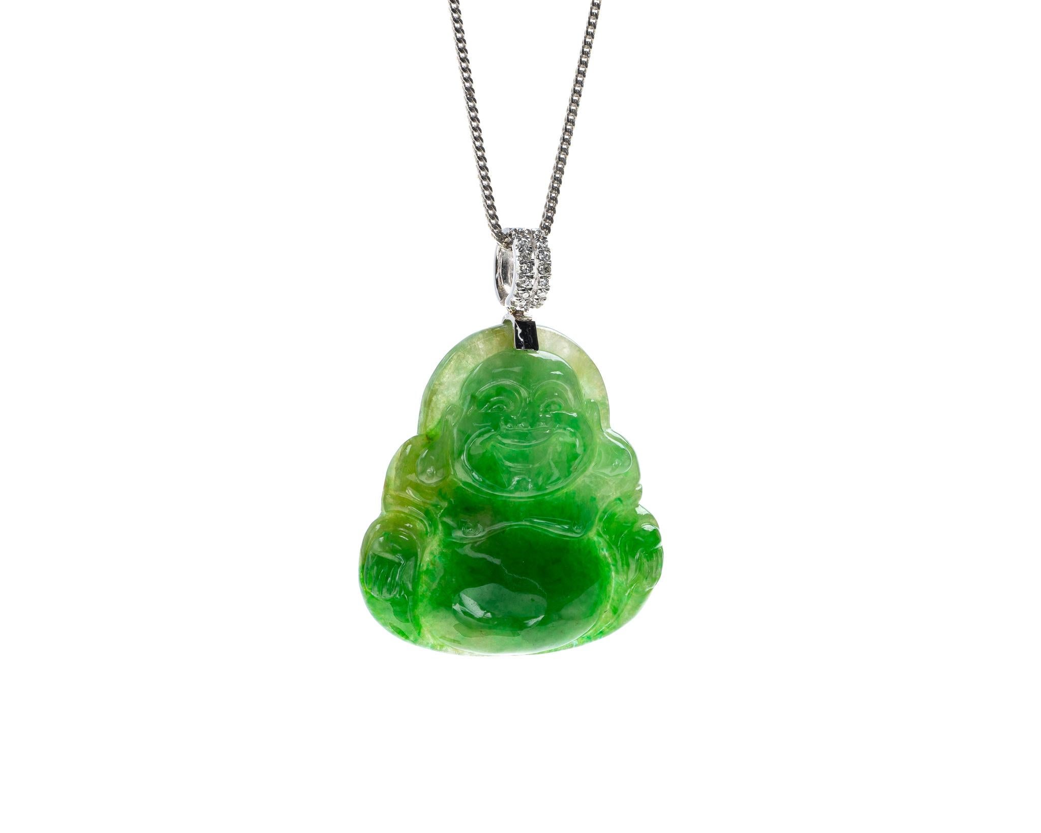This is an all natural, untreated green jadeite jade carved happy buddha and set on an 18K white gold and diamond bail.  The carved happy buddha symbolizes happiness, compassion and protection.   
 
It measures 1.11 inches (28.3 mm) x 1.47 inches