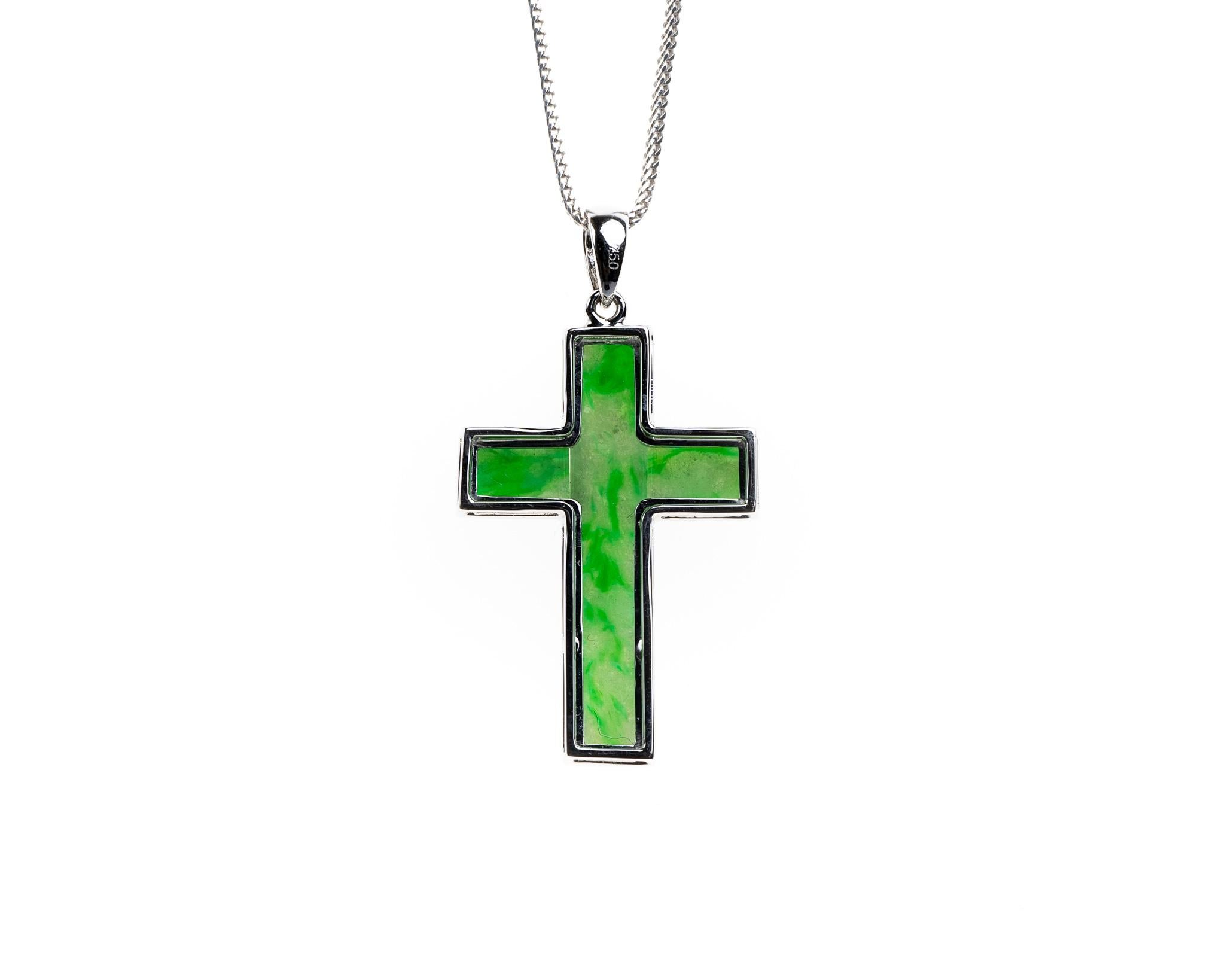 This all natural, untreated green jadeite jade carved cross with a 18k white gold setting. 

It measures 0.81 inches (20.8mm) x 1.19 inches (30.3mm) and thickness 0.20 inches (5.1mm). 

Included is a Hong Kong Gems Laboratory Jade Identification