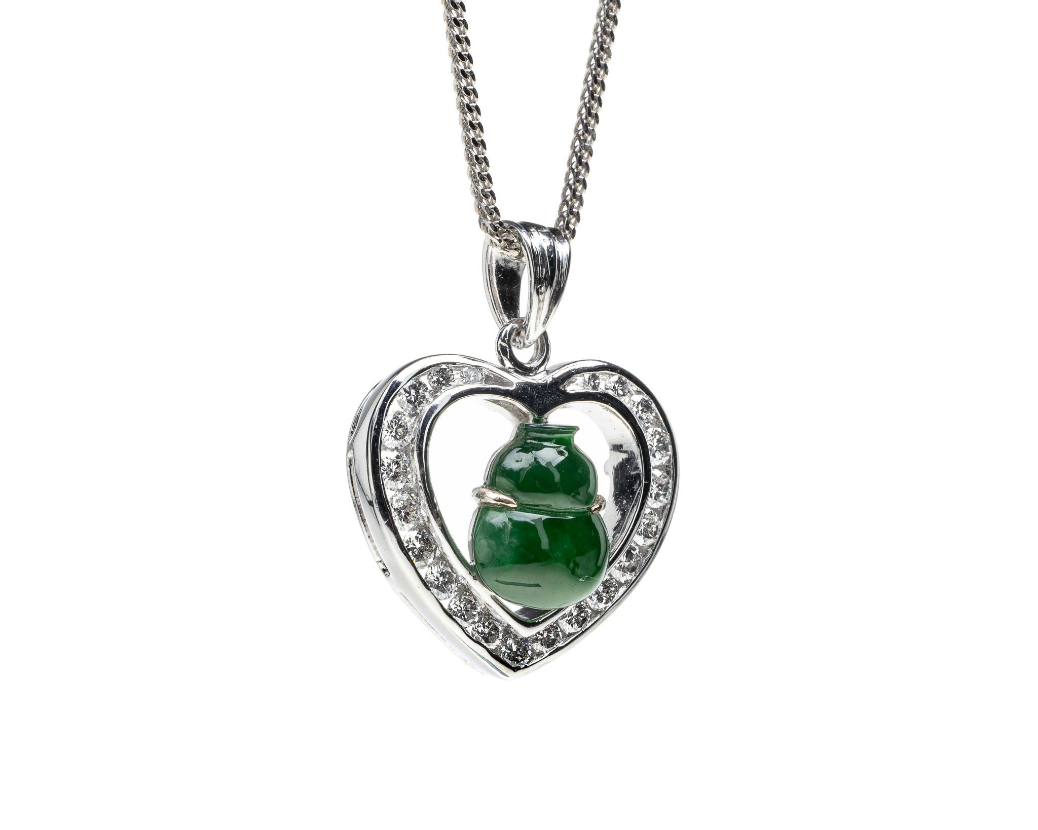 This is an all natural, untreated jadeite jade carved gourd and diamond pendant set on an 18K white gold and diamond bail.  The carved gourd symbolizes protection, great health and longevity.   

It measures 0.82 inches (21 mm) x 0.71 inches (18.1