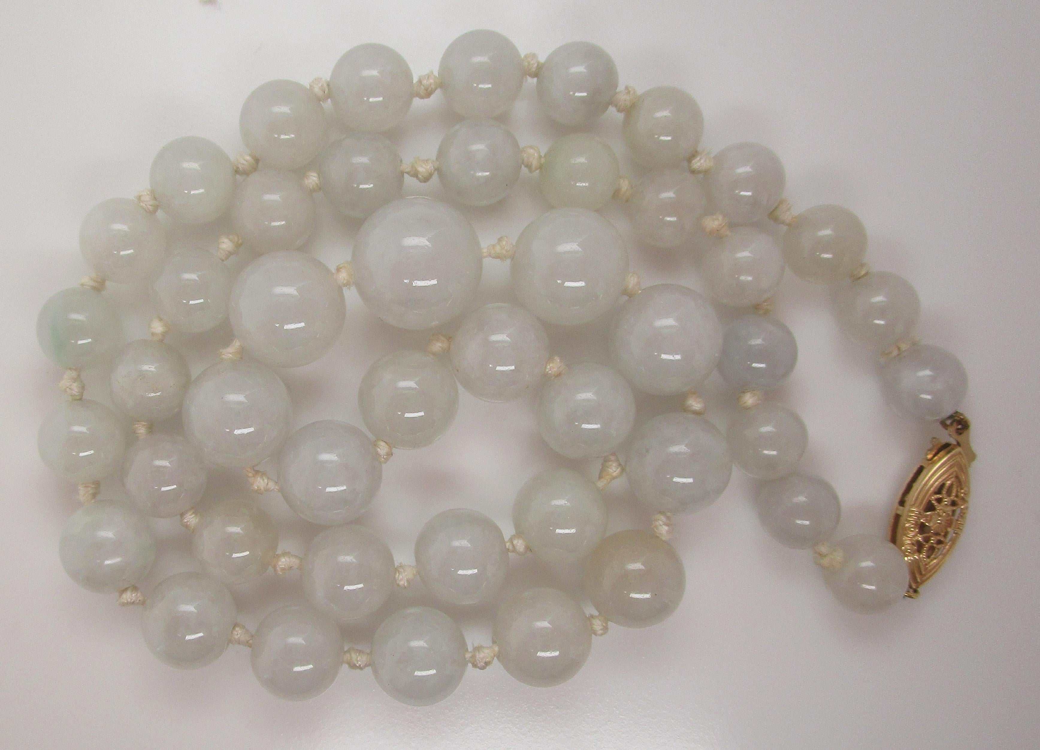 This is a beautiful strand of graduated green jadeite jade beads with a delicate 14k yellow gold filigree clasp. The jade has a lovely natural green color and is translucent. This is a gorgeous set of jade beads for the lover of jade or the person