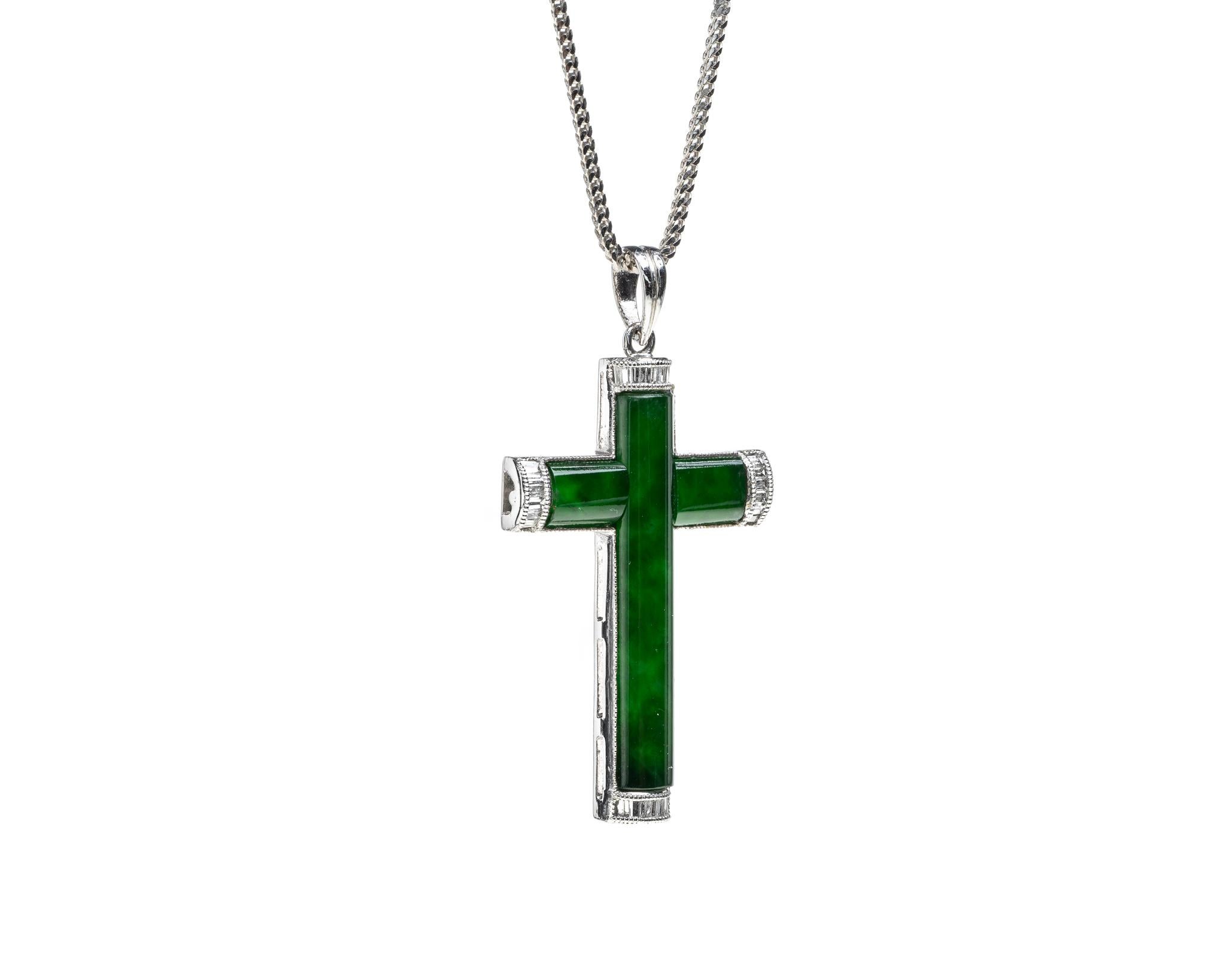 This all natural, untreated green jadeite jade carved cross with a 18k white gold and tapered baguette diamond setting with total diamond weight of 0.15 carats. 

It measures 1.13 inches (28.8mm) x 0.74 inches (19 mm) and thickness 0.13 inches (3.3