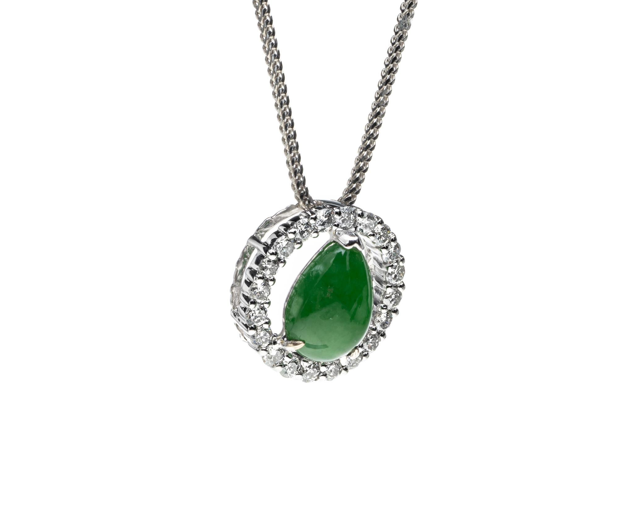 This is an all natural green jadeite jade carved pear shape set with a diamond halo pendant. 
 
It measures 0.53 inches (13.5 mm) x 0.53 inches (13.5 mm) and thickness of 0.25 inches (6.5 mm) with total diamond weight of 0.40 carats. 

Included is a