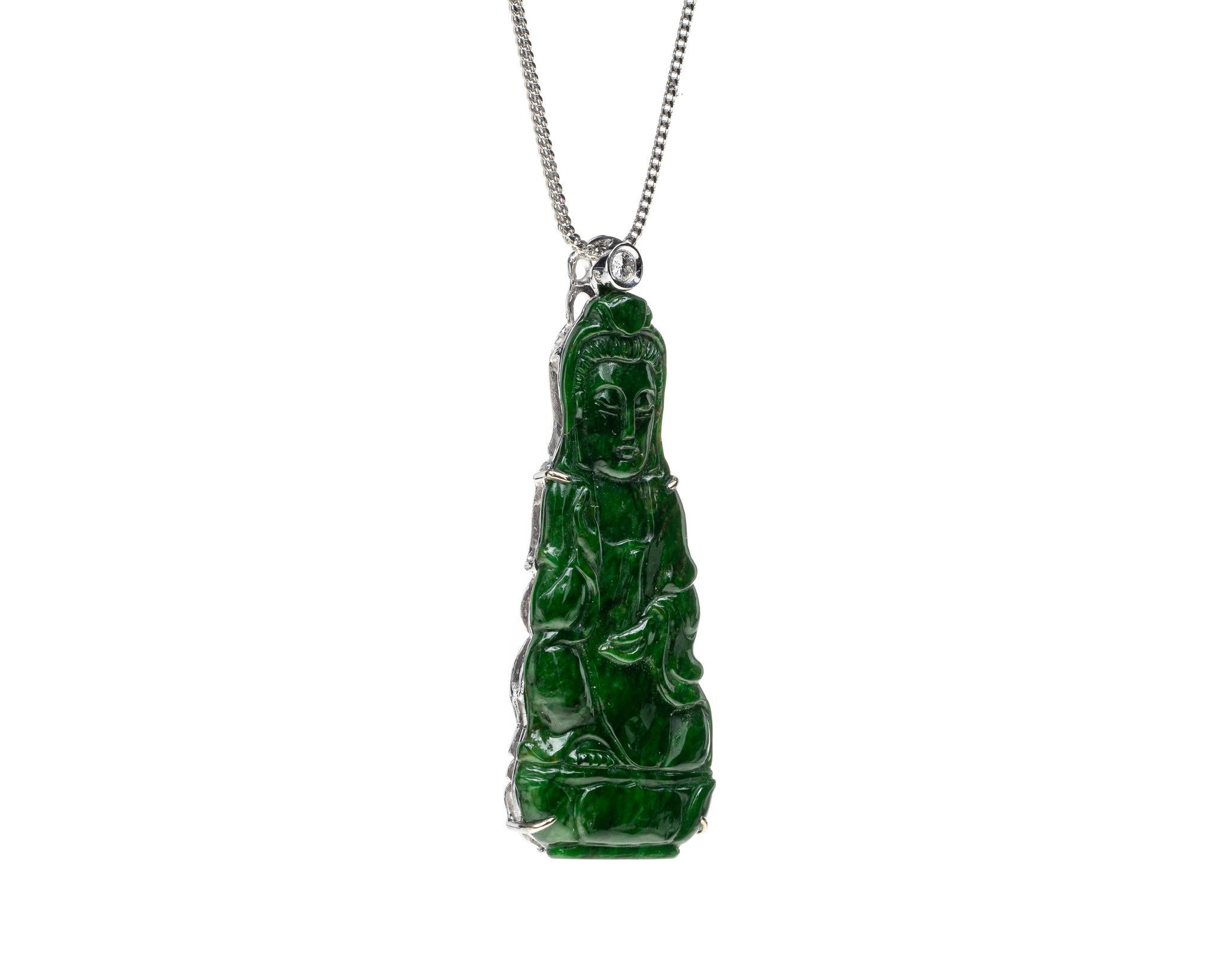 This is an all natural, untreated green jadeite jade carved Quan Yin god pendant set on an 18K white gold bail.  The carved Quan Yin god symbolizes compassion and protection. 

It measures 1.89  inches (48.2 mm) x 0.75 inches (19.2 mm) with