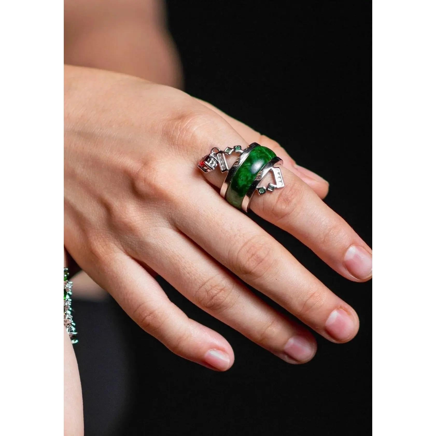 This one-of-a-kind cocktail ring features natural jadeite jade, untreated and polished to a silky smooth finish. Beautifully accented with garnet, emerald, ruby, and diamond, this exquisite piece exudes timeless elegance and