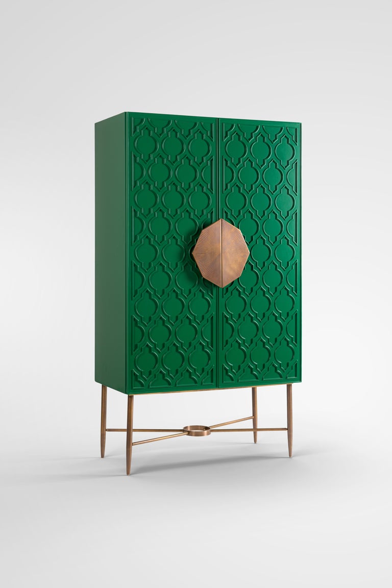 Green Lacquered Cabinet with Islamic Pattern and Hand-Crafted Brass Handle. 
Our Andalusia Art Deco cabinet is inspired from our rich Islamic heritage. It is designed using an Islamic motif and painted in royal green for an artsy pop of color to