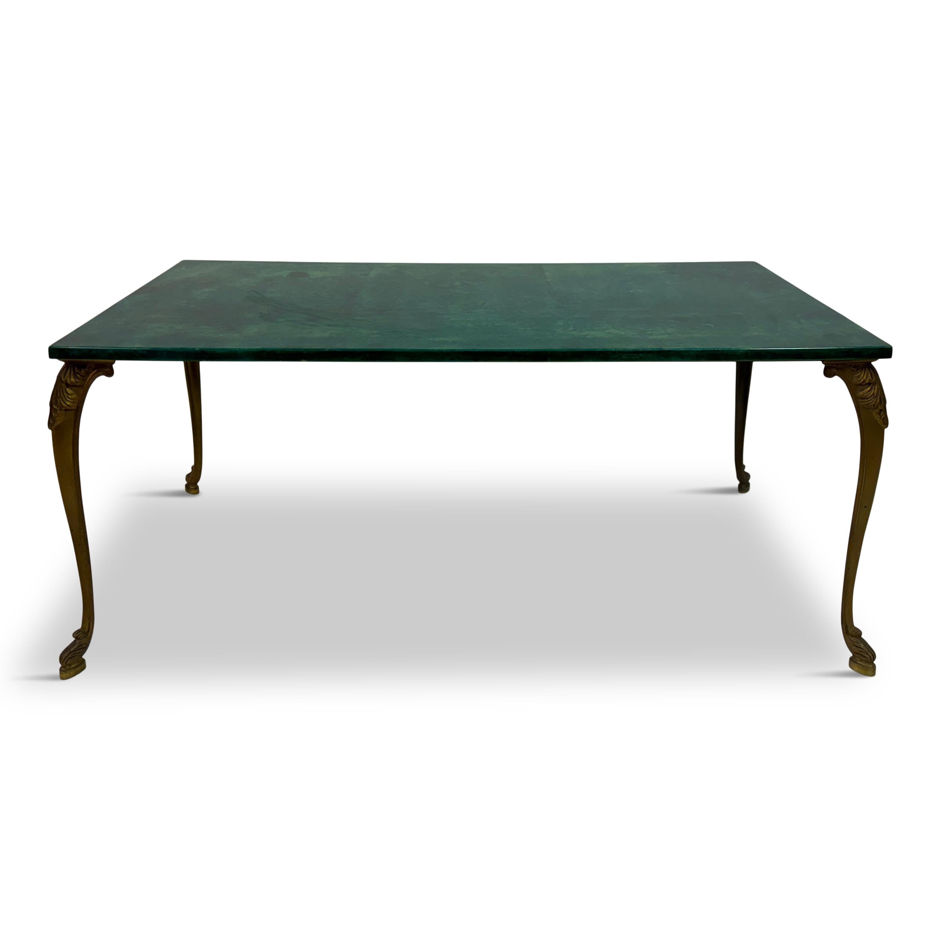 1960s lacquered green goatskin coffee table, by the renowned Italian designer Aldo Tura.

This vintage piece embodies Tura's signature luxurious style, featuring a rich green goatskin top meticulously lacquered to a high gloss finish. The elegant
