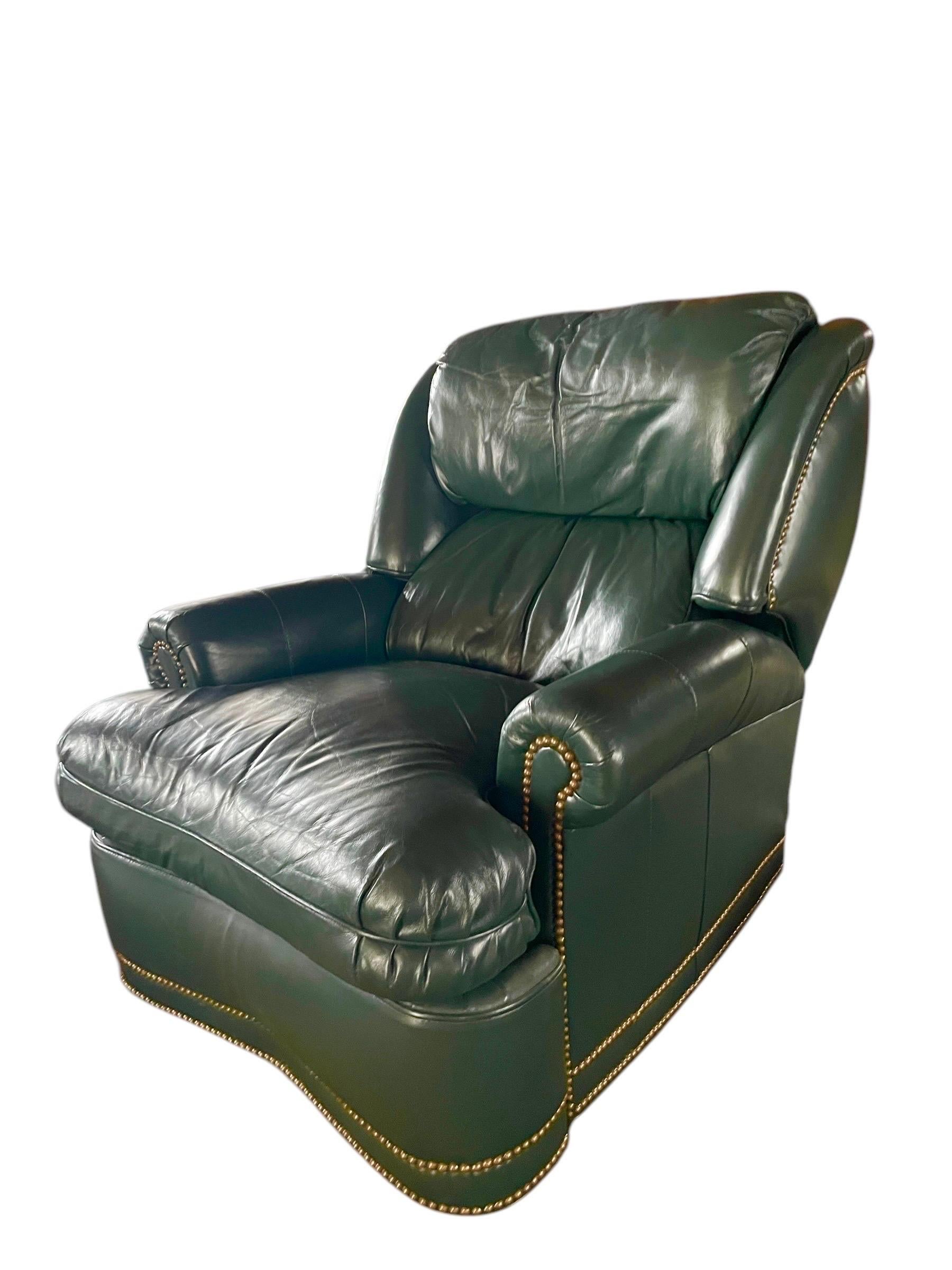 This is a classic vintage staple! Reclining deep hunter green leather armchair with brass tacks by Hancock and Moore. Top tier quality, incredibly comfortable top grain leather. The generous arm rests and back have a “sink into me” level of comfort.