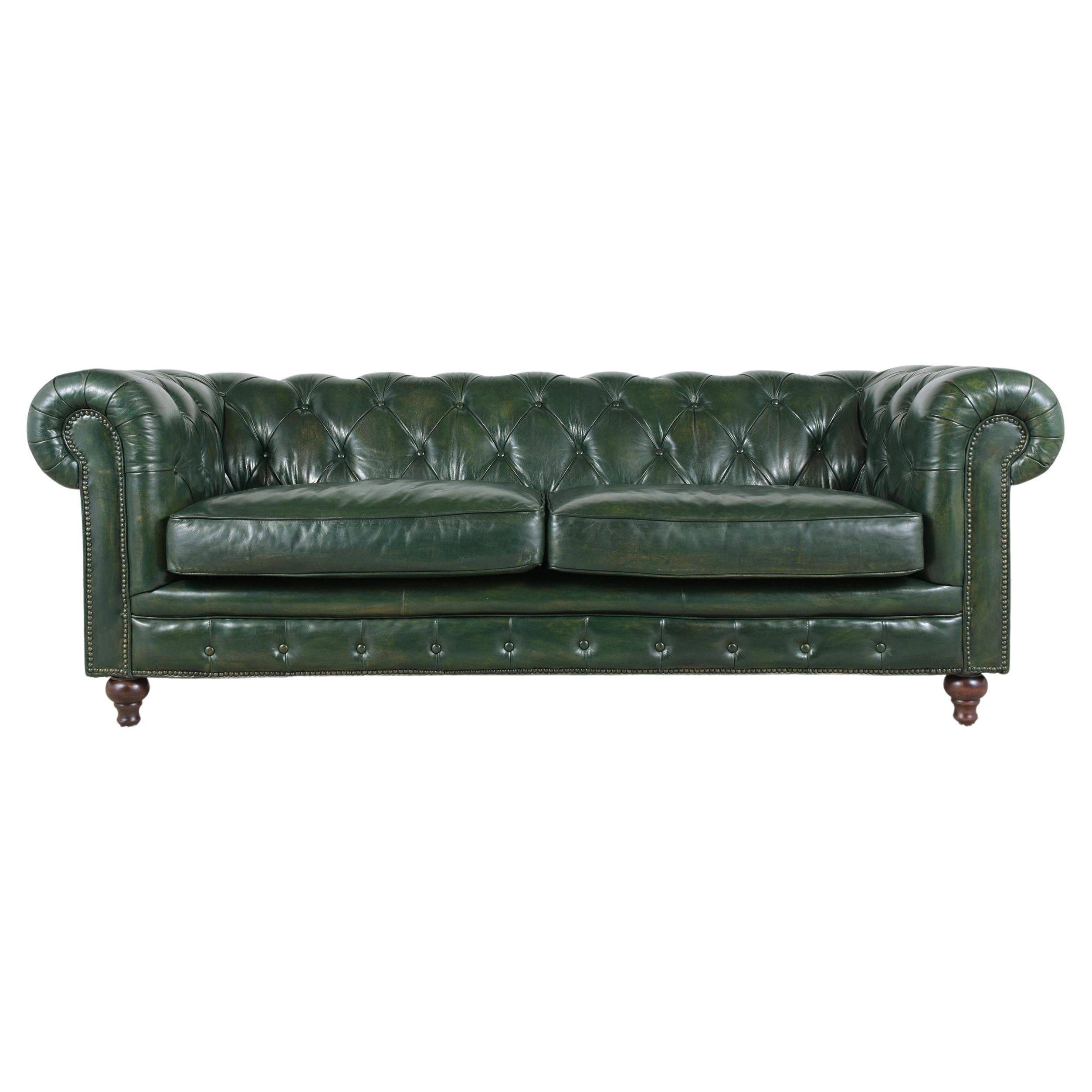 An extraordinary vintage chesterfield sofa in great condition that has been completed restored by our craftsmen. This fabulous sofa features a round tufted backrest & arms, offers a two-seat cushion all covered in leather newly dye in green color