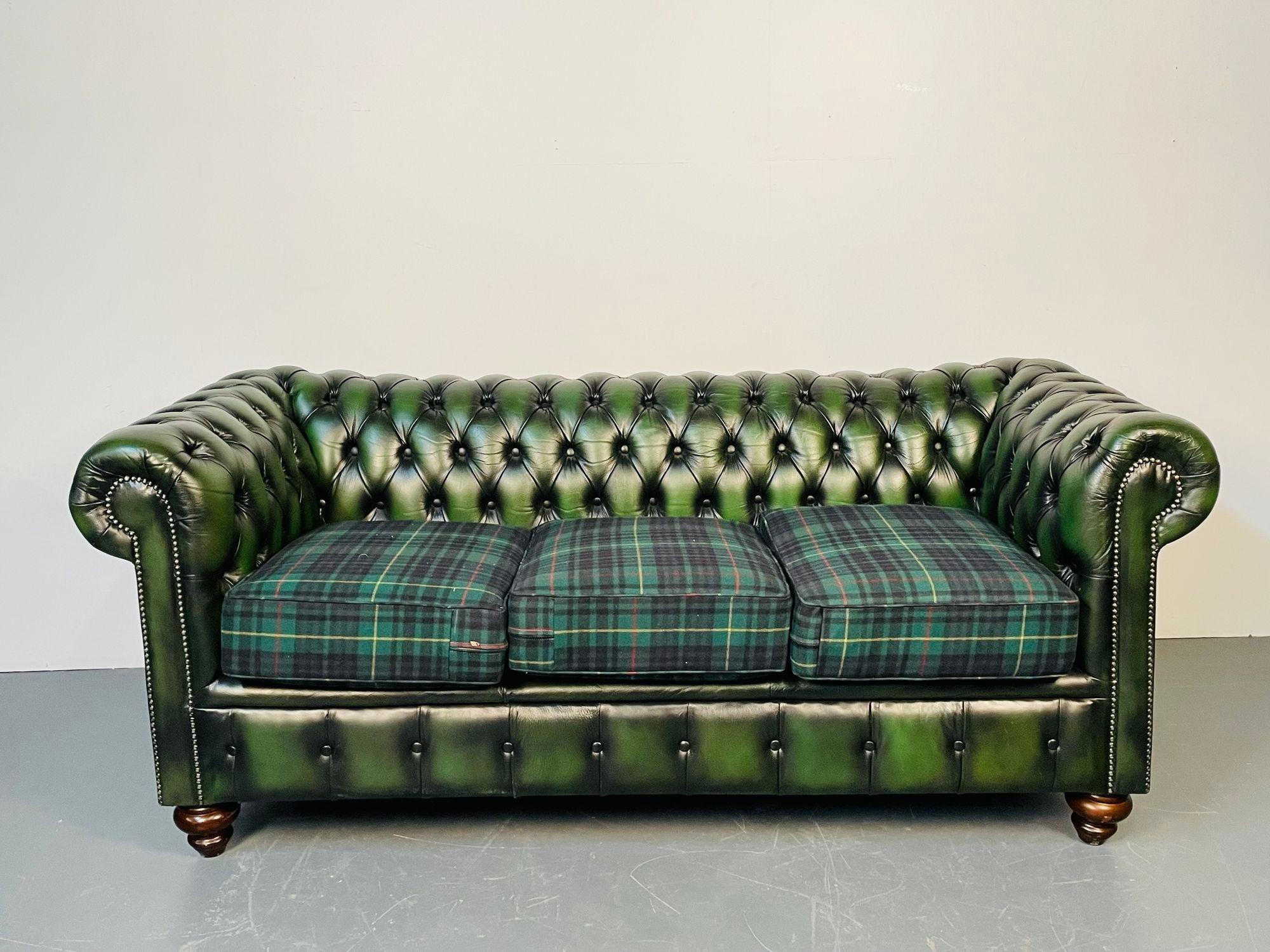 A green leather chesterfield sofa or settee style of Ralph Lauren 
A fine leather fully tufted chesterfield with plaid seat cushions in the Georgian style on mahogany bun feet. In good overall condition. 
Measures: 31H x 76W x 35D / SH 21
lXX