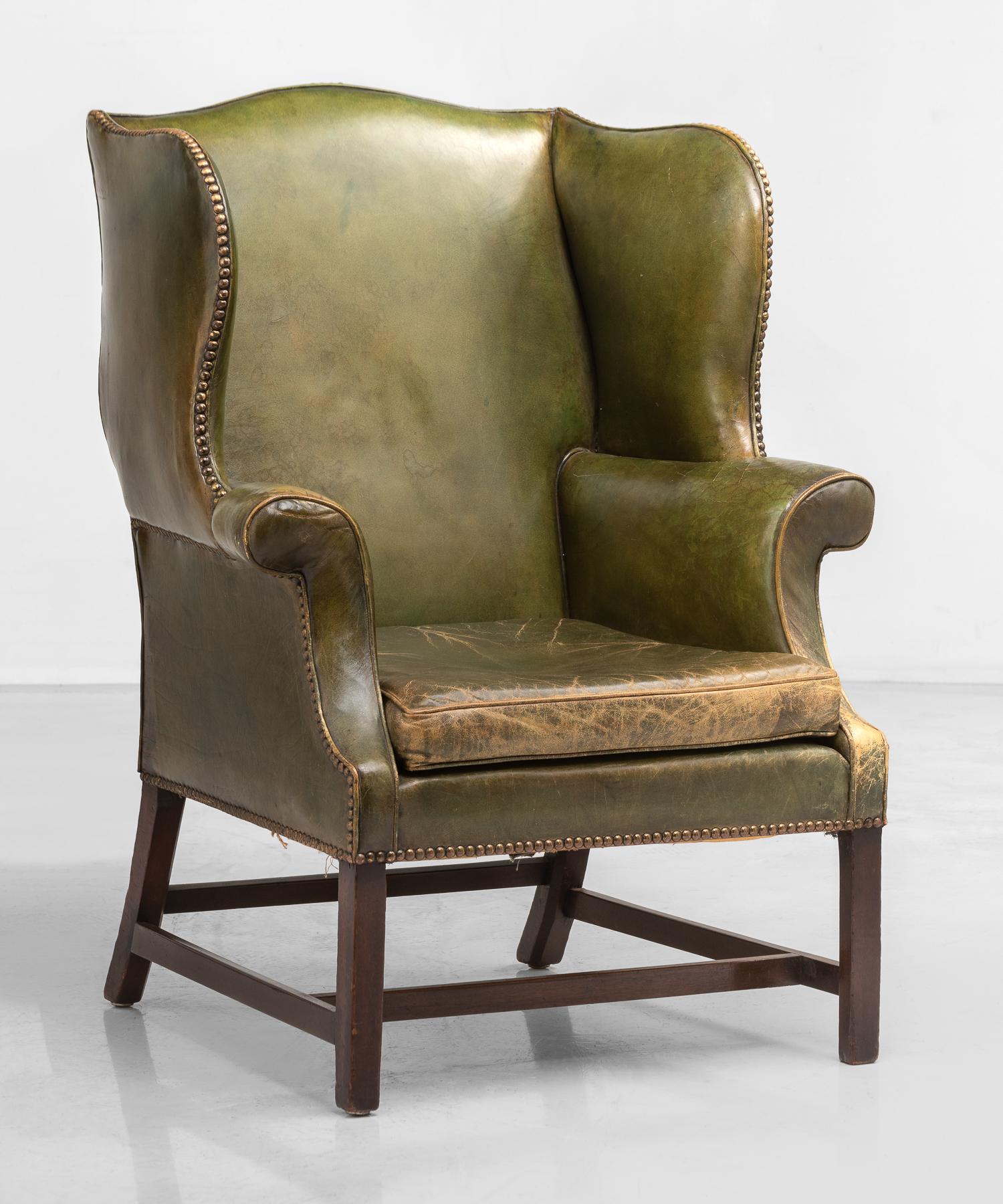 Green leather wingback chair, England, circa 1920

Generously sized form in a beautiful, patinated green leather, which includes studded details.