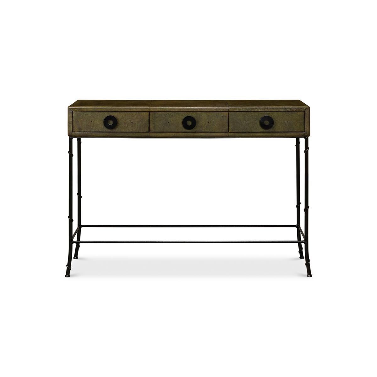 Dark Green Leather Wrapped Console Table. With its stunning faux shagreen embossed green leather wrap adorning the upper section, this piece is the perfect blend of sophistication and practicality. The three lined frieze drawers, with bold circular