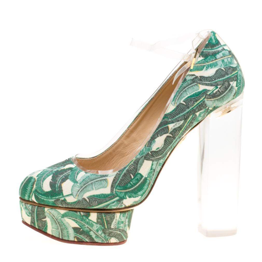 With her bold and stylish creations, Charlotte Olympia has paved her way into every woman's wardrobe! These Mabel pumps are crafted from canvas and PVC and feature green leaves printed all over them. They flaunt almond toes, PVC buckled ankle