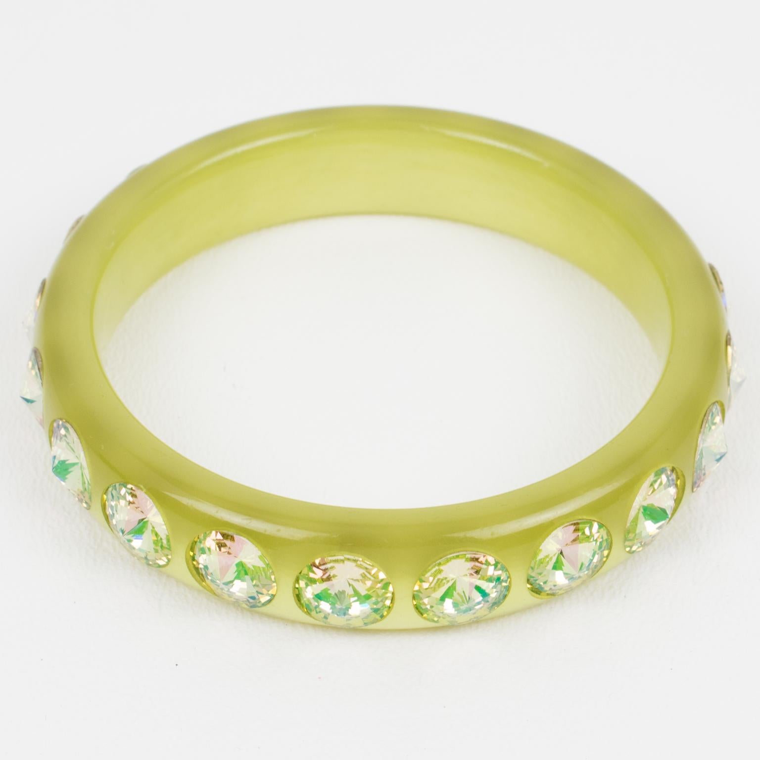 This superb Lucite bracelet bangle features a domed shape in an avocado green color. The bangle is ornate with massive pale yellow glitter crystal rhinestones. There is no visible maker's mark.
Measurements: Inside across is 2.57 in diameter (6.5