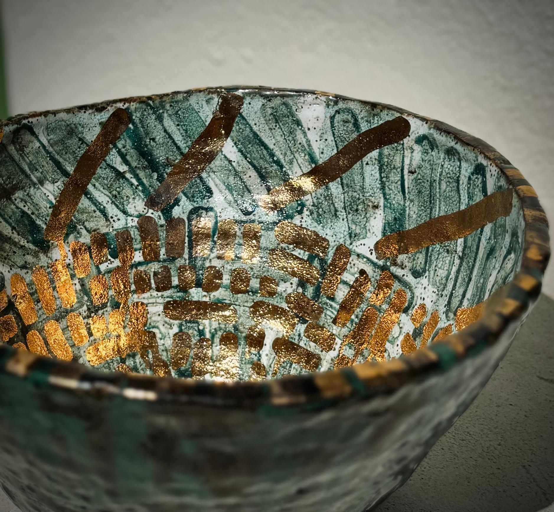 With a nod to the spontaneity and privileged imperfection that is the human condition, all of my pieces imbue an energy of function and whimsy.

This decorative speckled stoneware coil built bowl is glittering with textured gold luster over sheer