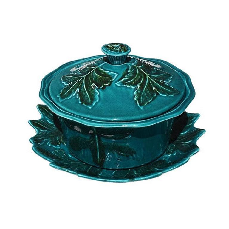 A polychrome verdigris green and blue majolica California Pottery Serving Tureen with lid and underplate. This set will be great for serving soups, casseroles, or a variety of other dishes. An underplate is decorated with raised leaves glazed in a