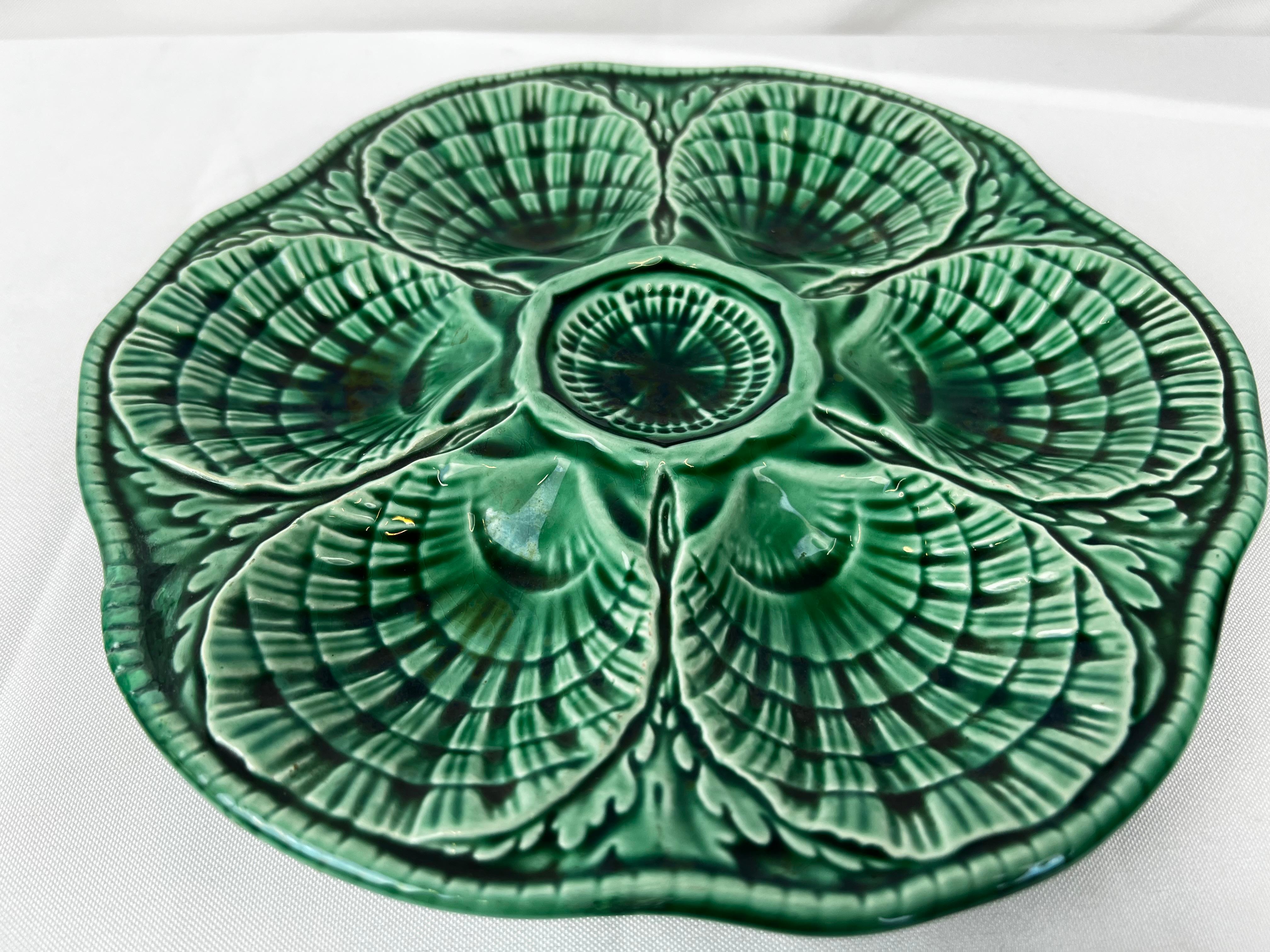Majolica oyster plate in a rich Ming green coloration.  Sarreguemines, a prolific ceramics company in France, created this plate in the 1930’s.  It could hold six large oysters with room in the center for a complimentary sauce/spice/lemon.  The